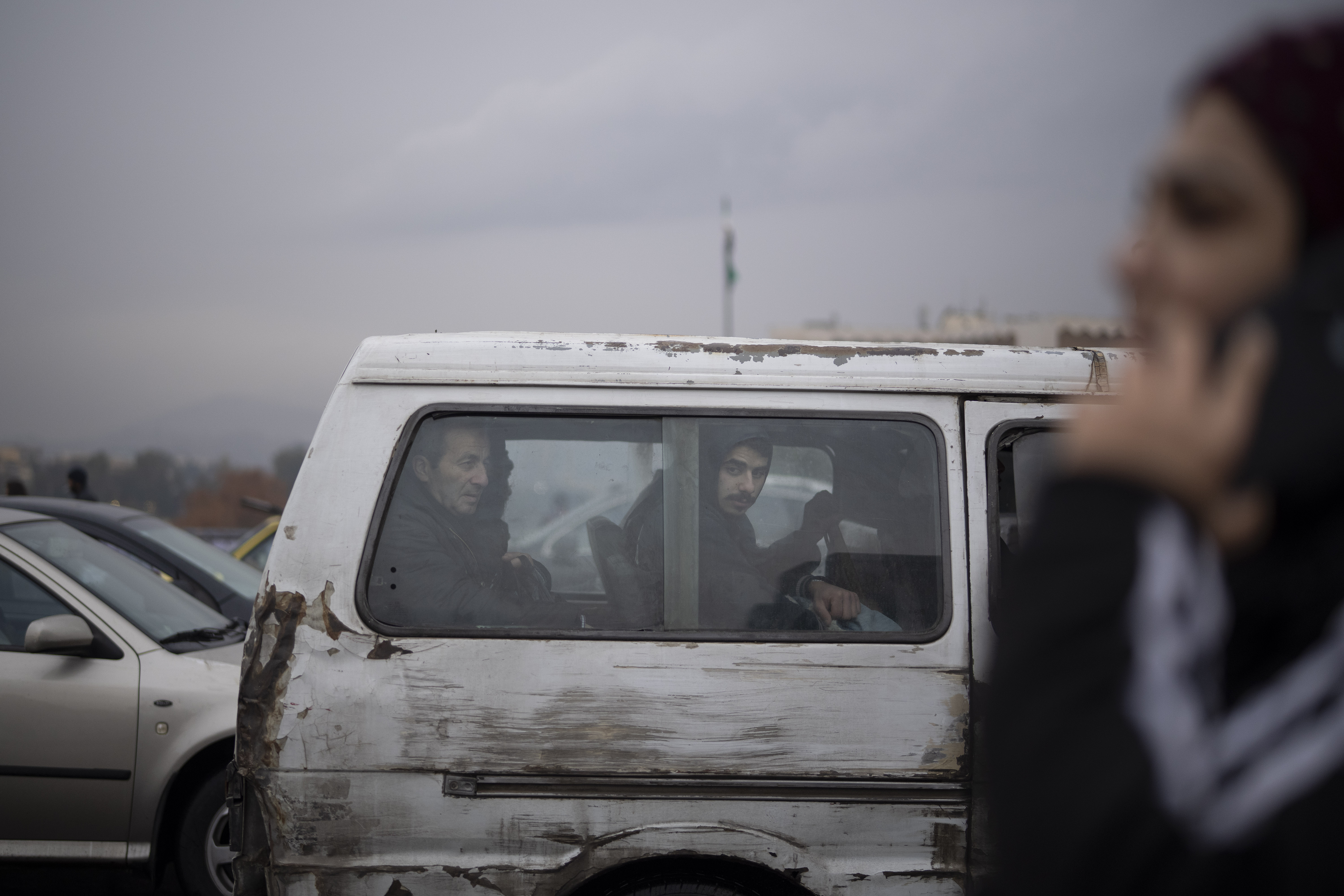 Commuters ride on a transportation van in Damascus, Syria, Sunday, Dec. 29, 2024. (AP Photo/Leo Correa)