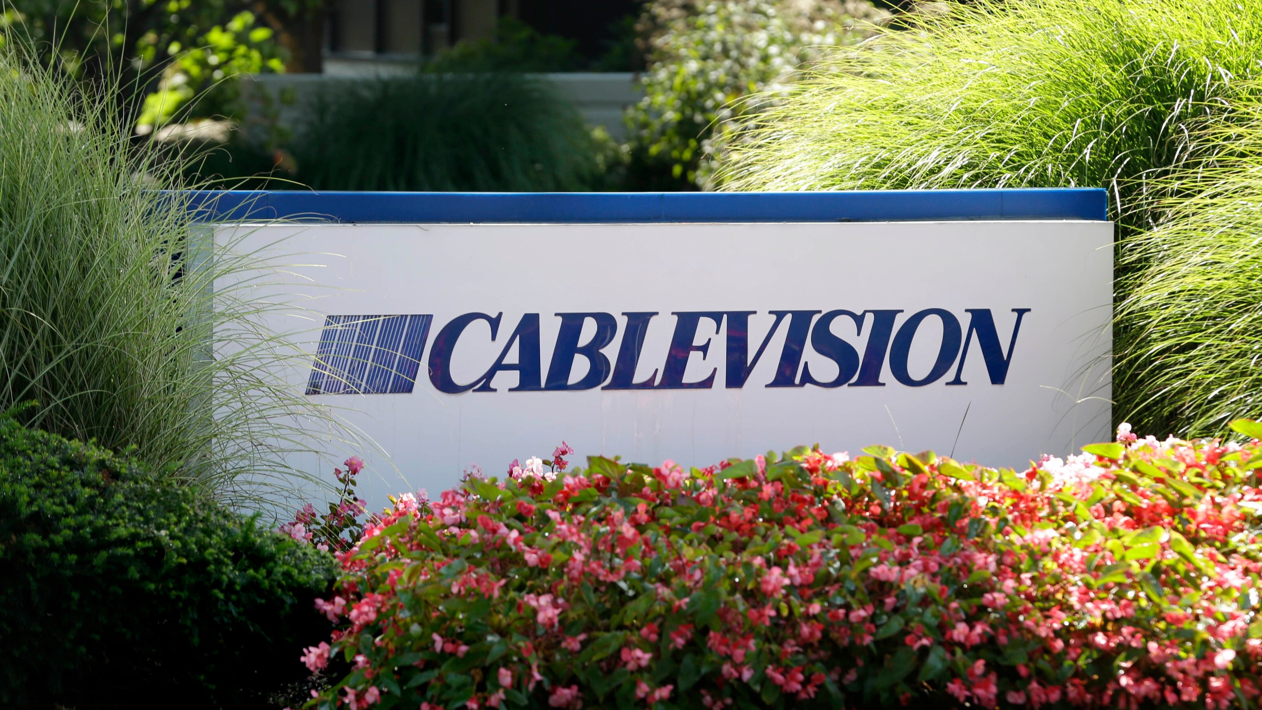 FILE - A sign is displayed at Cablevision headquarters in Bethpage, N.Y., on Sept. 17, 2015. (AP Photo/Seth Wenig, File)