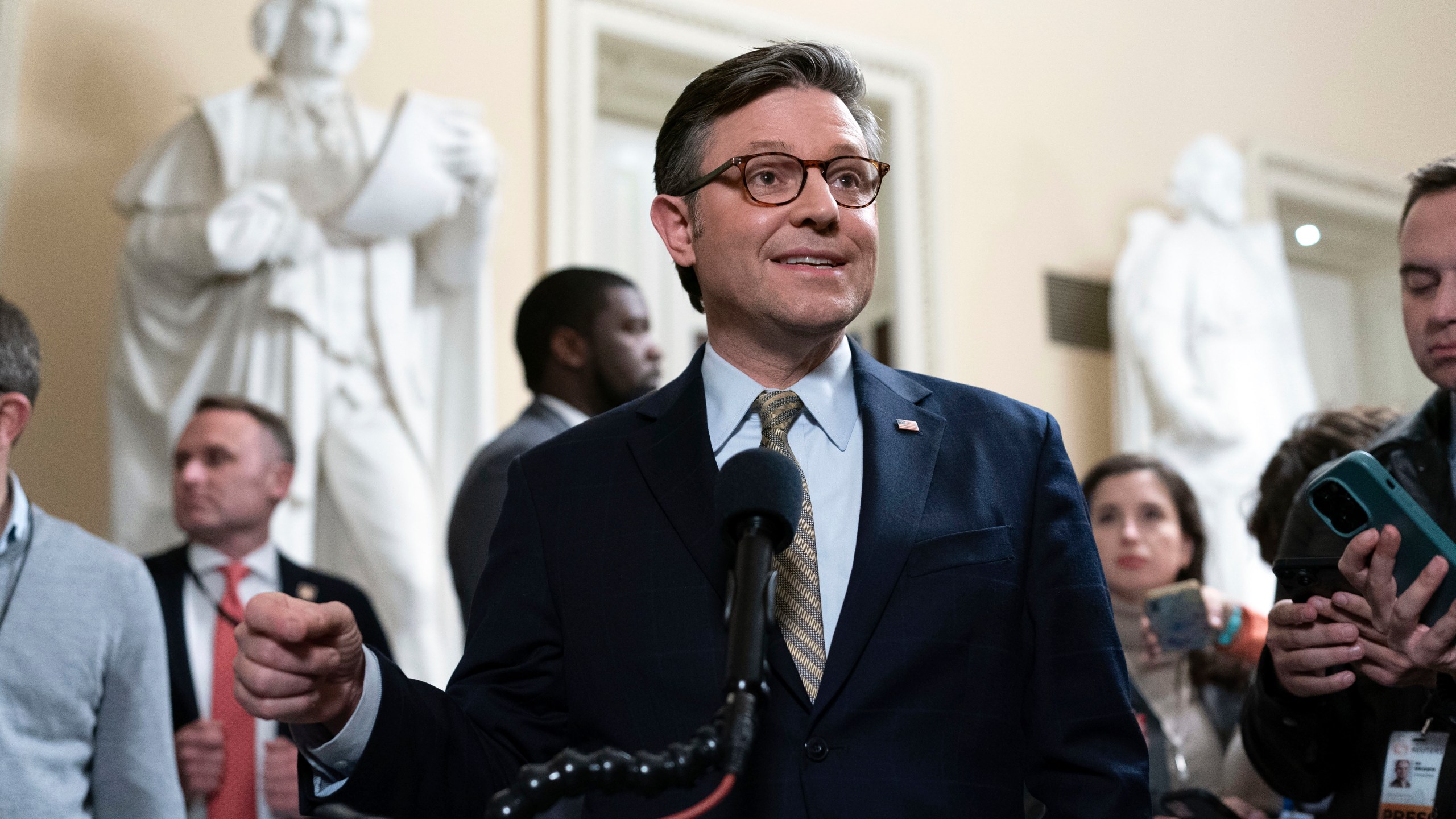 Speaker of the House Mike Johnson, R-La., talks to reporters after passing the funding bill to avert the government shutdown at the Capitol in Washington, Friday, Dec. 20, 2024. (AP Photo/Jose Luis Magana)