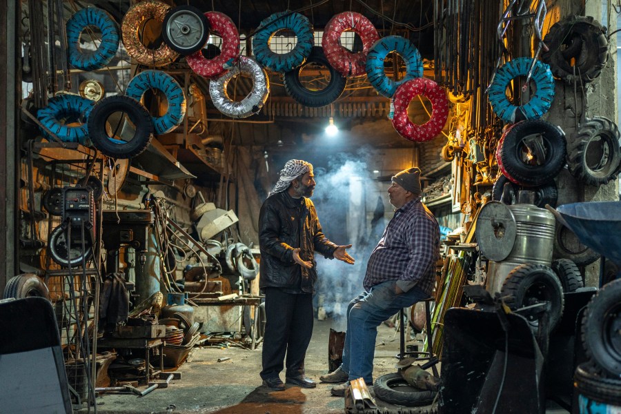 Wokers at a tyre shop wait for customers in Douma, on the outskirts of Damascus, Syria, Sunday, Dec. 29, 2024 (AP Photo/Mosa'ab Elshamy)