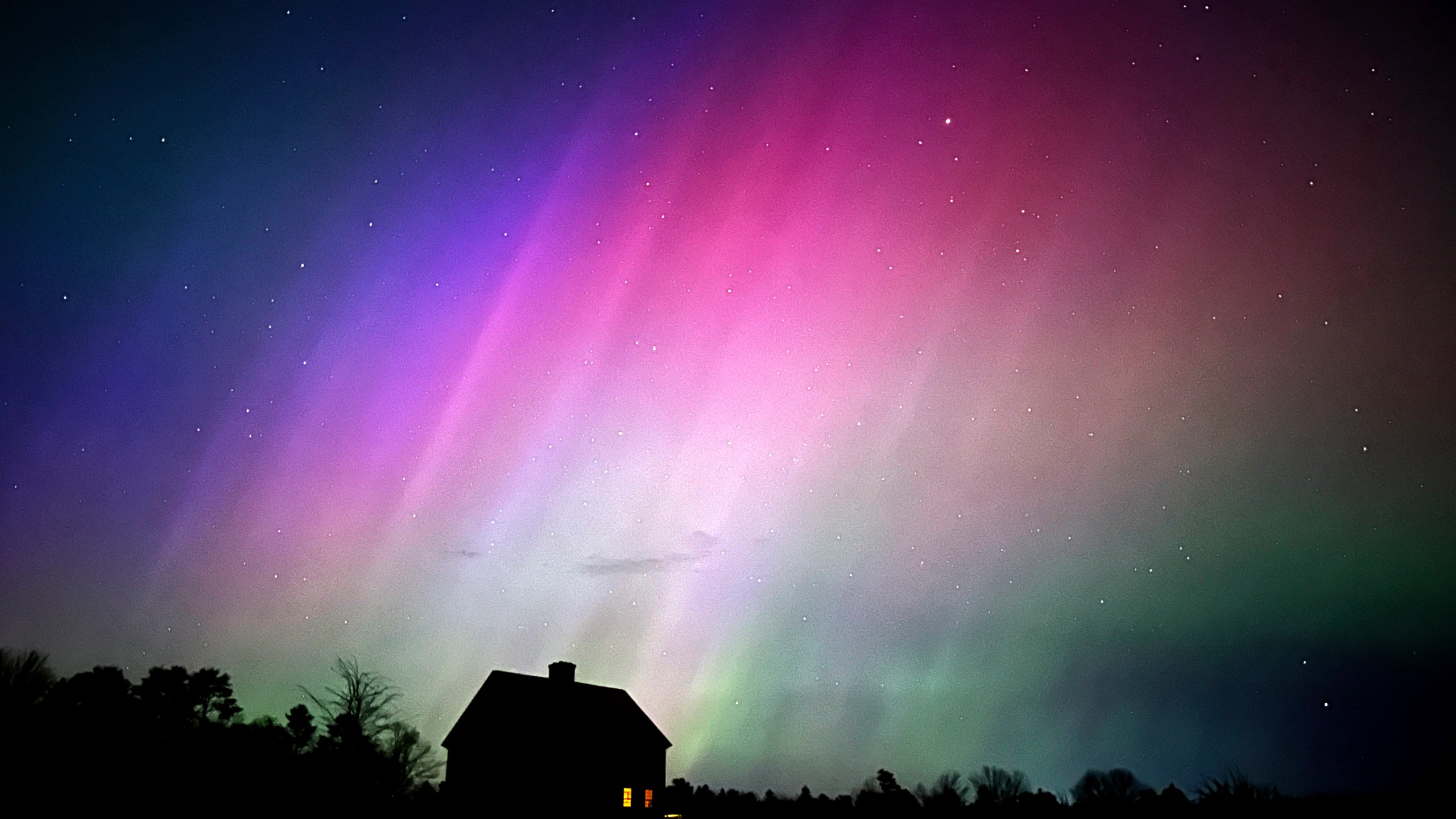 FILE - The northern lights flare in the sky over a farmhouse, May 10, 2024, in Brunswick, Maine. (AP Photo/Robert F. Bukaty, File)