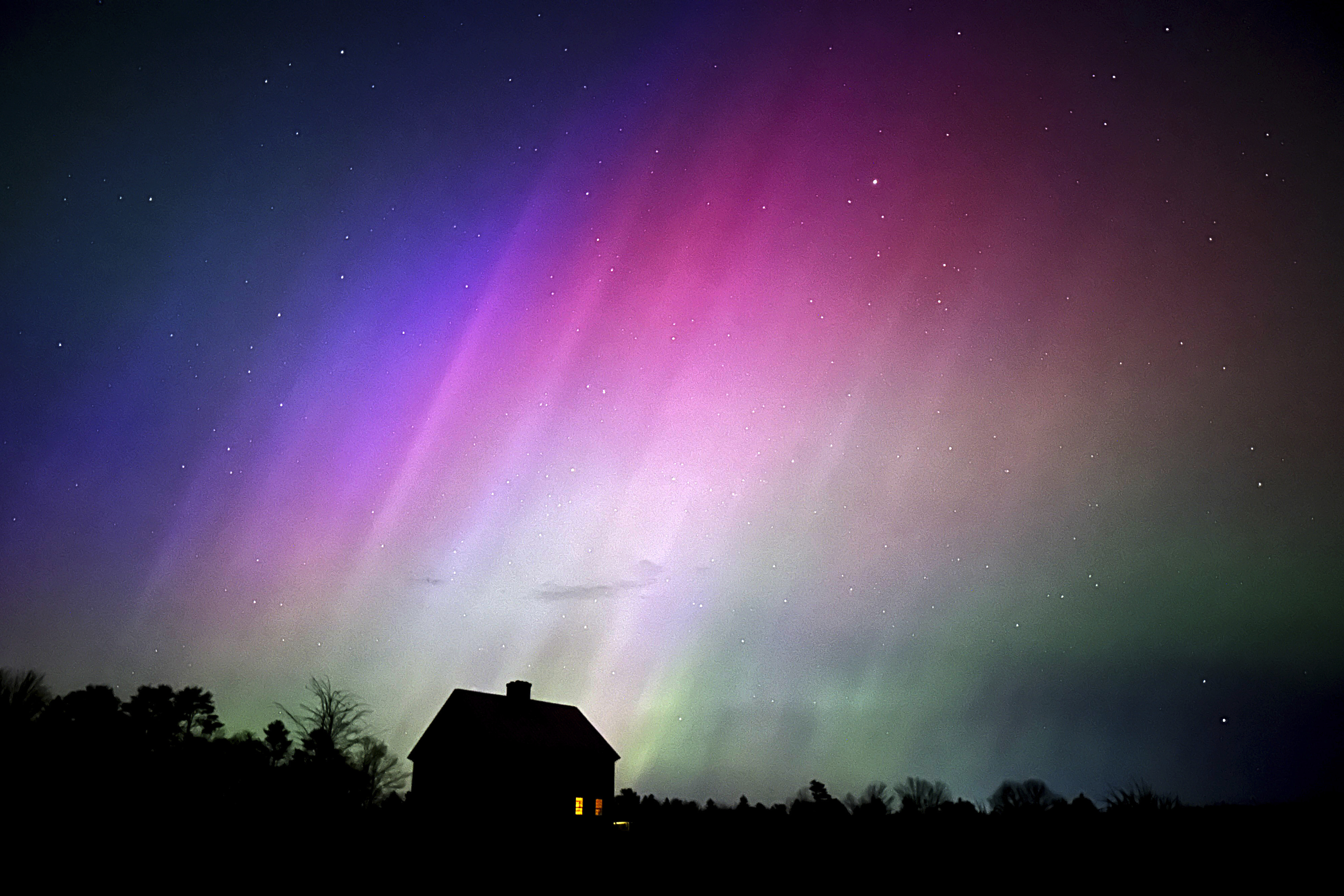 FILE - The northern lights flare in the sky over a farmhouse, May 10, 2024, in Brunswick, Maine. (AP Photo/Robert F. Bukaty, File)