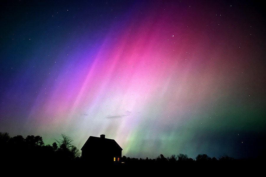 FILE - The northern lights flare in the sky over a farmhouse, May 10, 2024, in Brunswick, Maine. (AP Photo/Robert F. Bukaty, File)