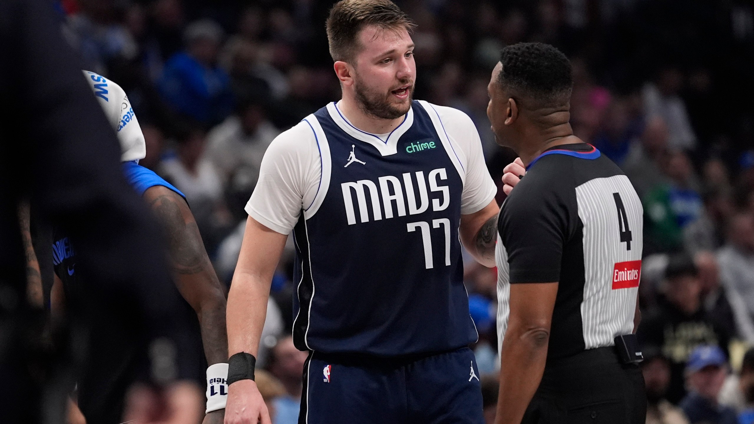 Dallas Mavericks guard Luka Doncic (77) questions a call by referee Sean Wright (4) during the first half of an NBA basketball game against the Portland Trail Blazers, Monday, Dec. 23, 2024, in Dallas. (AP Photo/LM Otero)