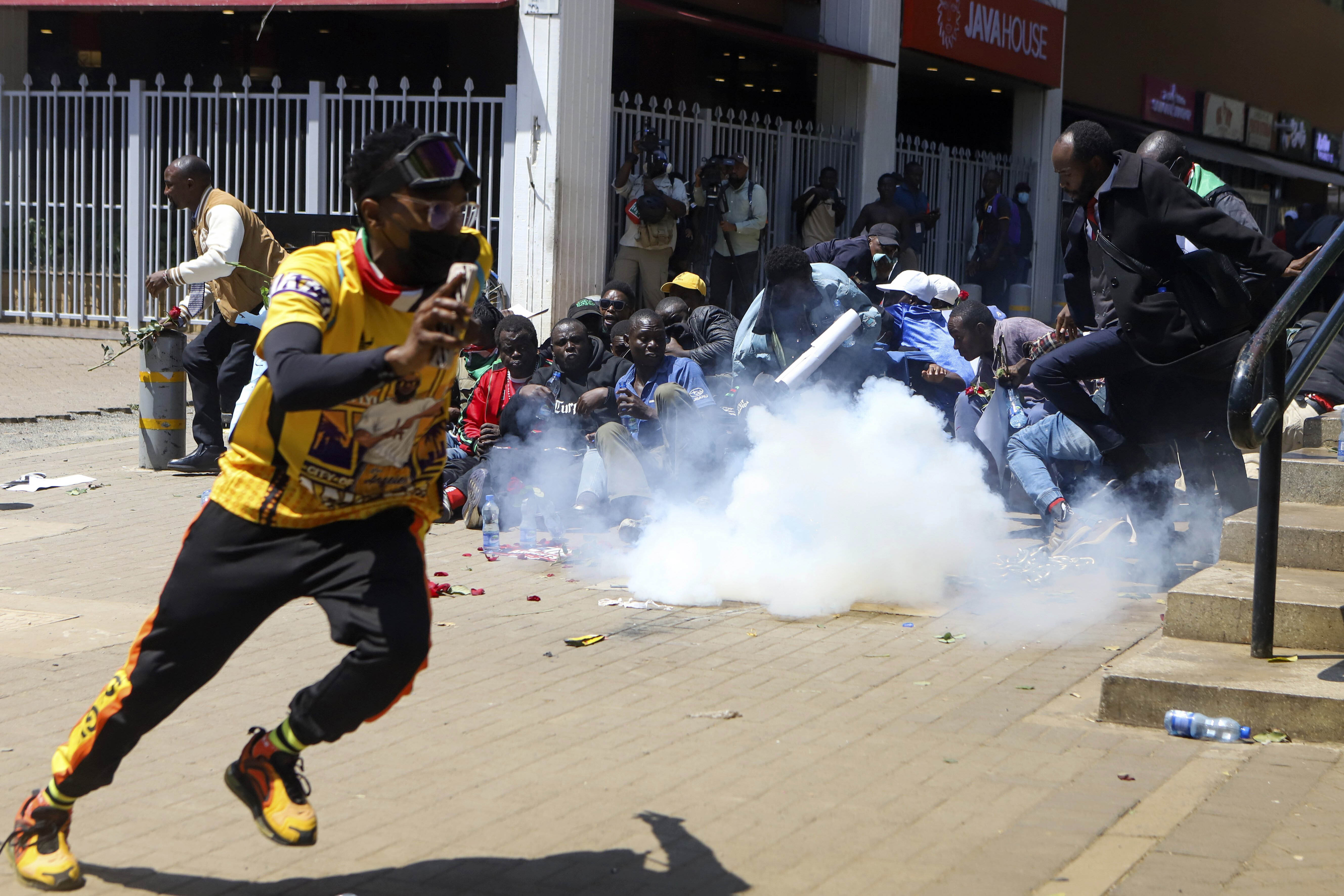 A man reacts after being tear-gassed by police during protests against abductions dubbed 'EndProtests' in Nairobi, Kenya, Monday, Dec. 30, 2024. (AP Photo/Andrew Kasuku)