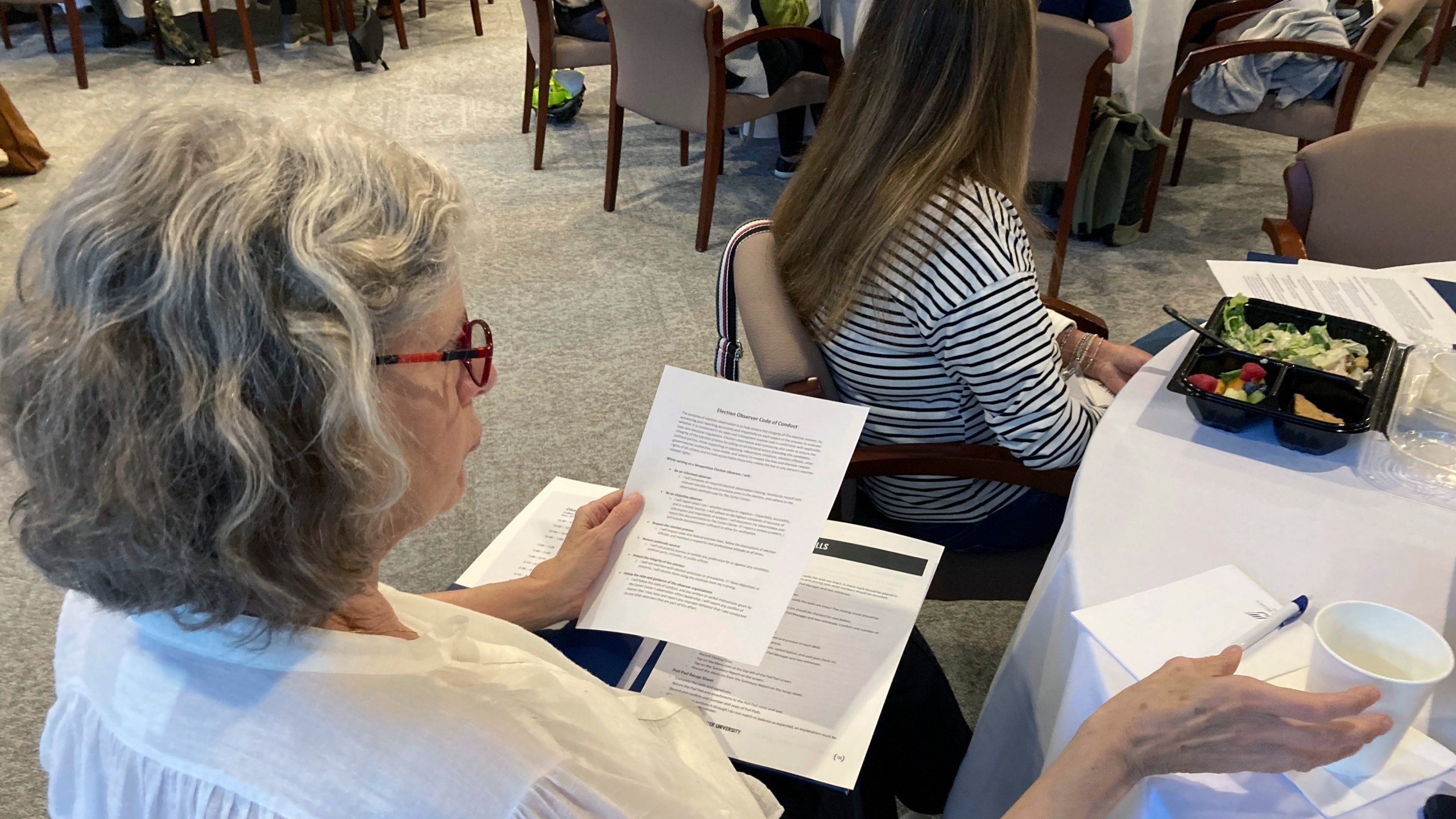 FILE - A volunteer election observer reviews training materials on Nov. 6, 2022, at the Carter Center in Atlanta. (AP Photo/Jeff Amy, File)