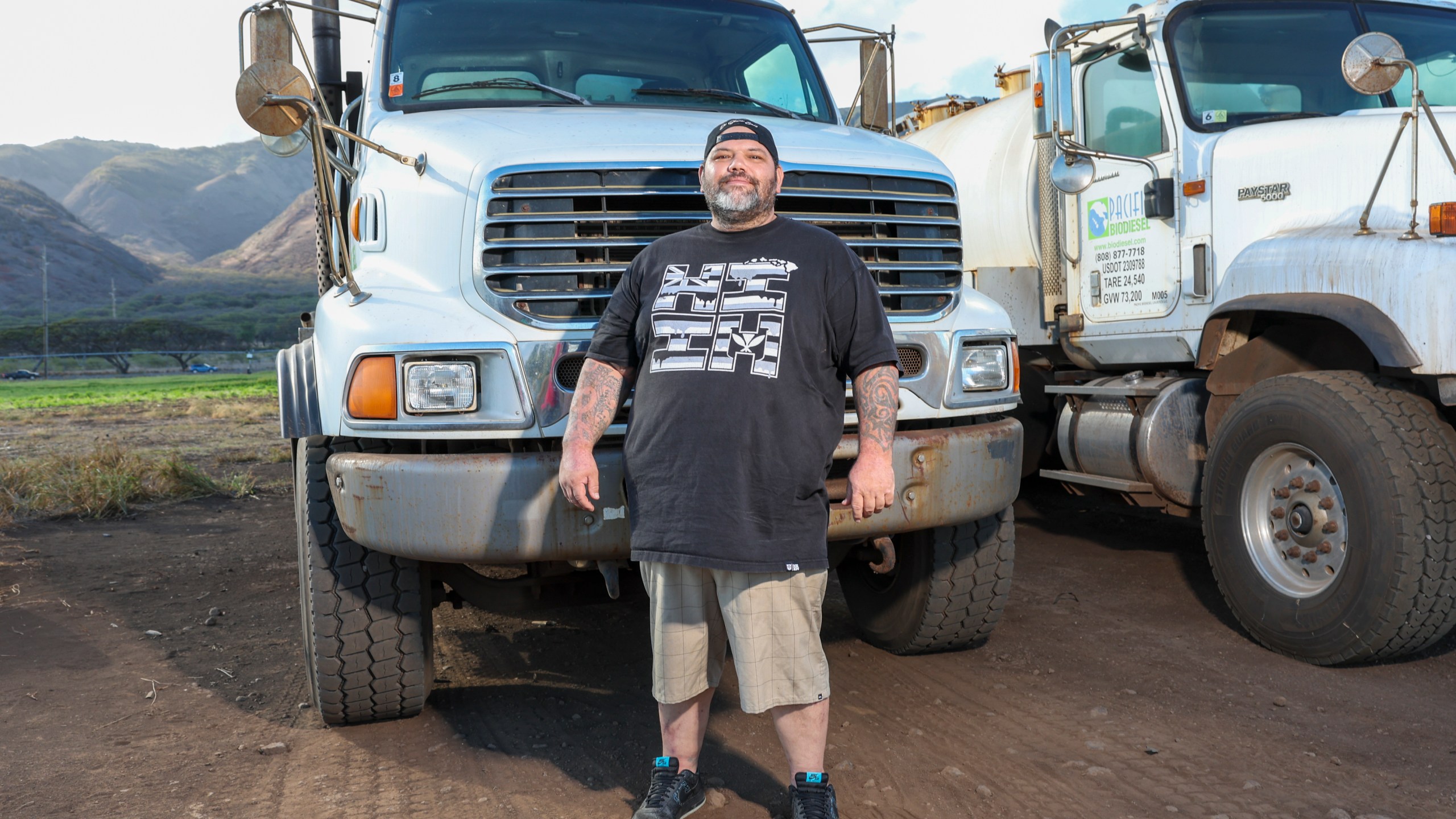 Joshua Kamalo, 43, stands by a truck he drives for work Wednesday, Dec. 18, 2024, in Maalaea, Hawaii. (AP Photo/Marco Garcia)