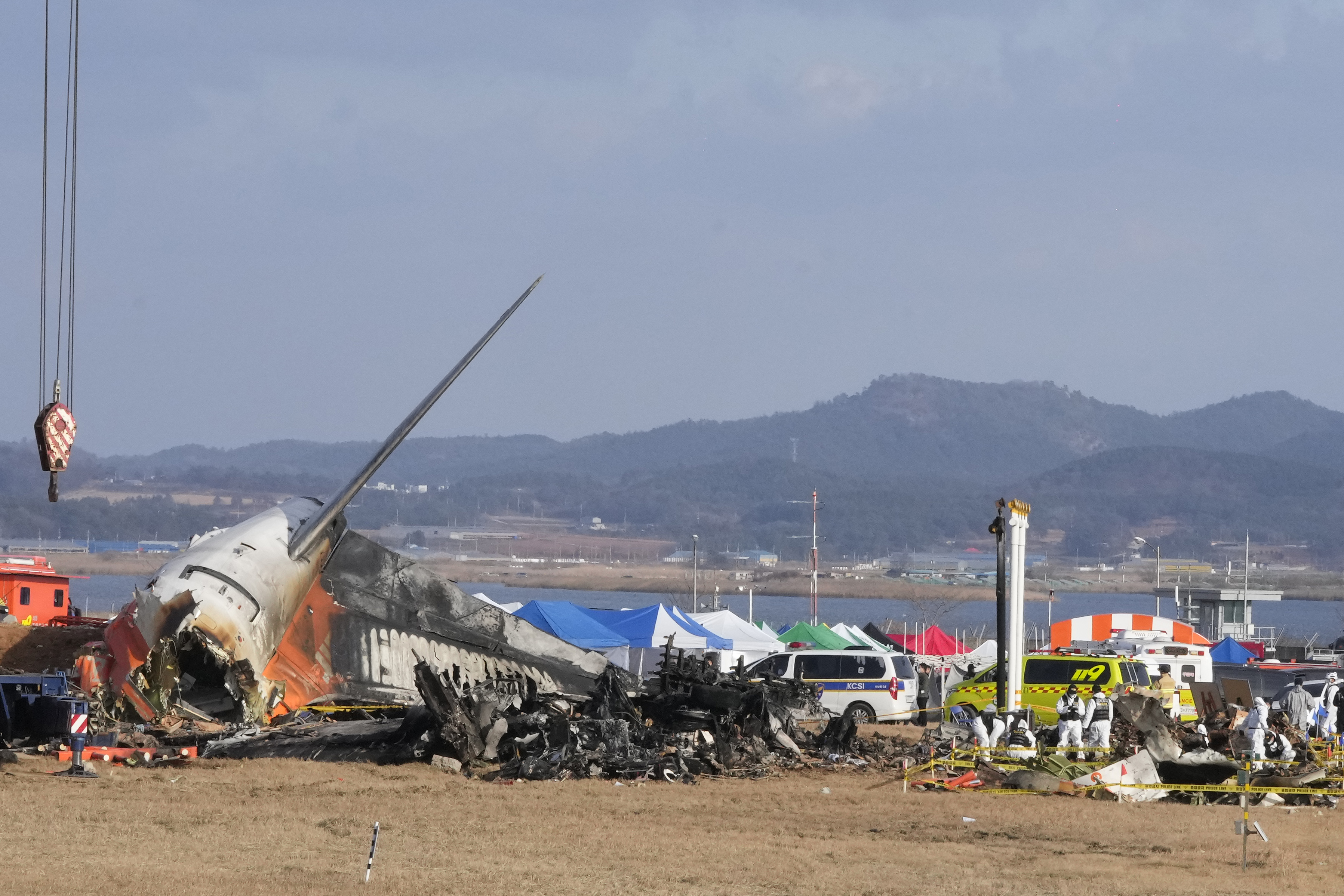 Rescue team members work at the site of a plane fire at Muan International Airport in Muan, South Korea, Monday, Dec. 30, 2024. (AP Photo/Ahn Young-joon)