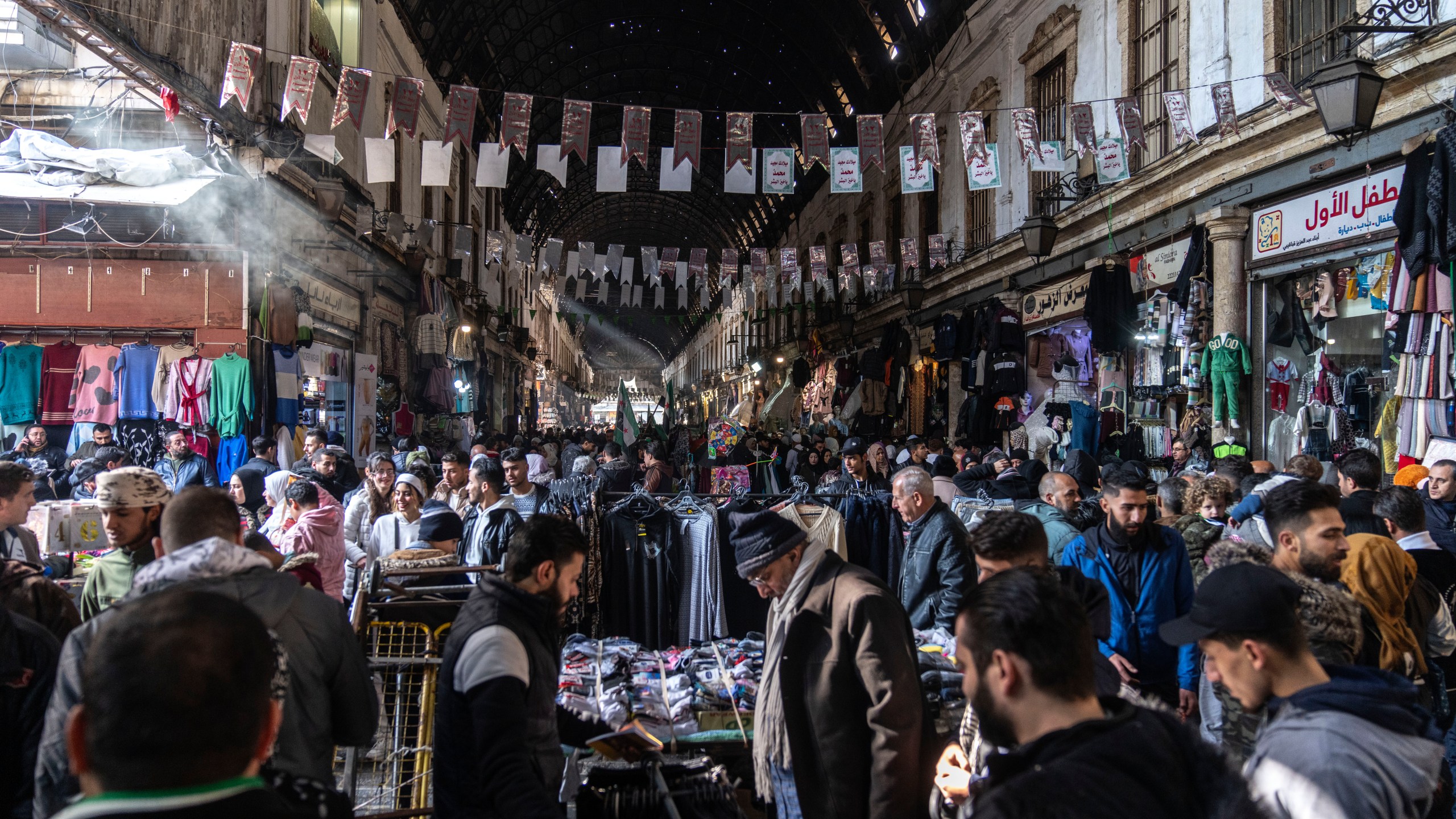 People shop for goods near Al-Hamidiyeh Souq on New Years Eve, in Damascus, Syria, Tuesday, Dec. 31, 2024 (AP Photo/Mosa'ab Elshamy)