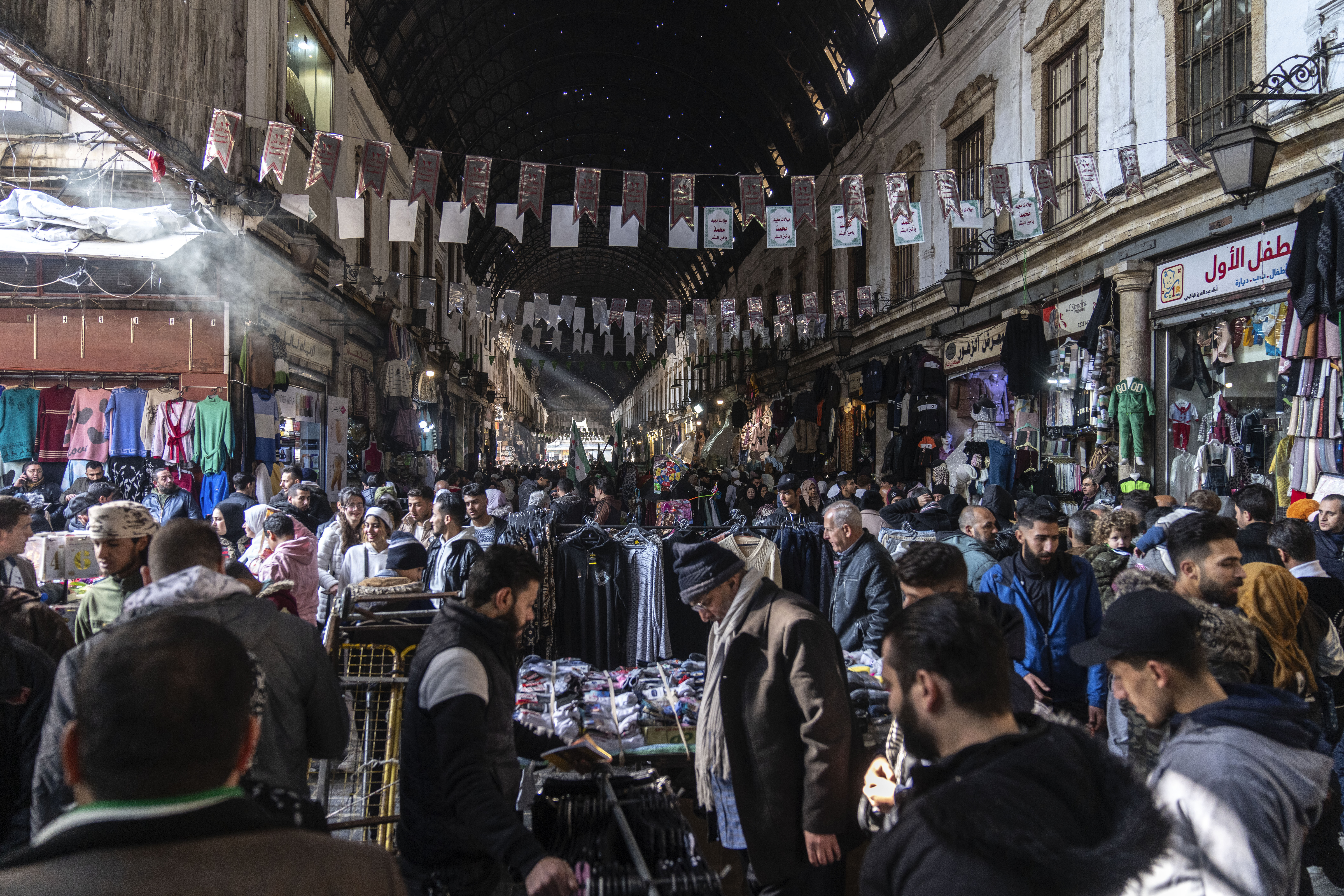 People shop for goods near Al-Hamidiyeh Souq on New Years Eve, in Damascus, Syria, Tuesday, Dec. 31, 2024 (AP Photo/Mosa'ab Elshamy)