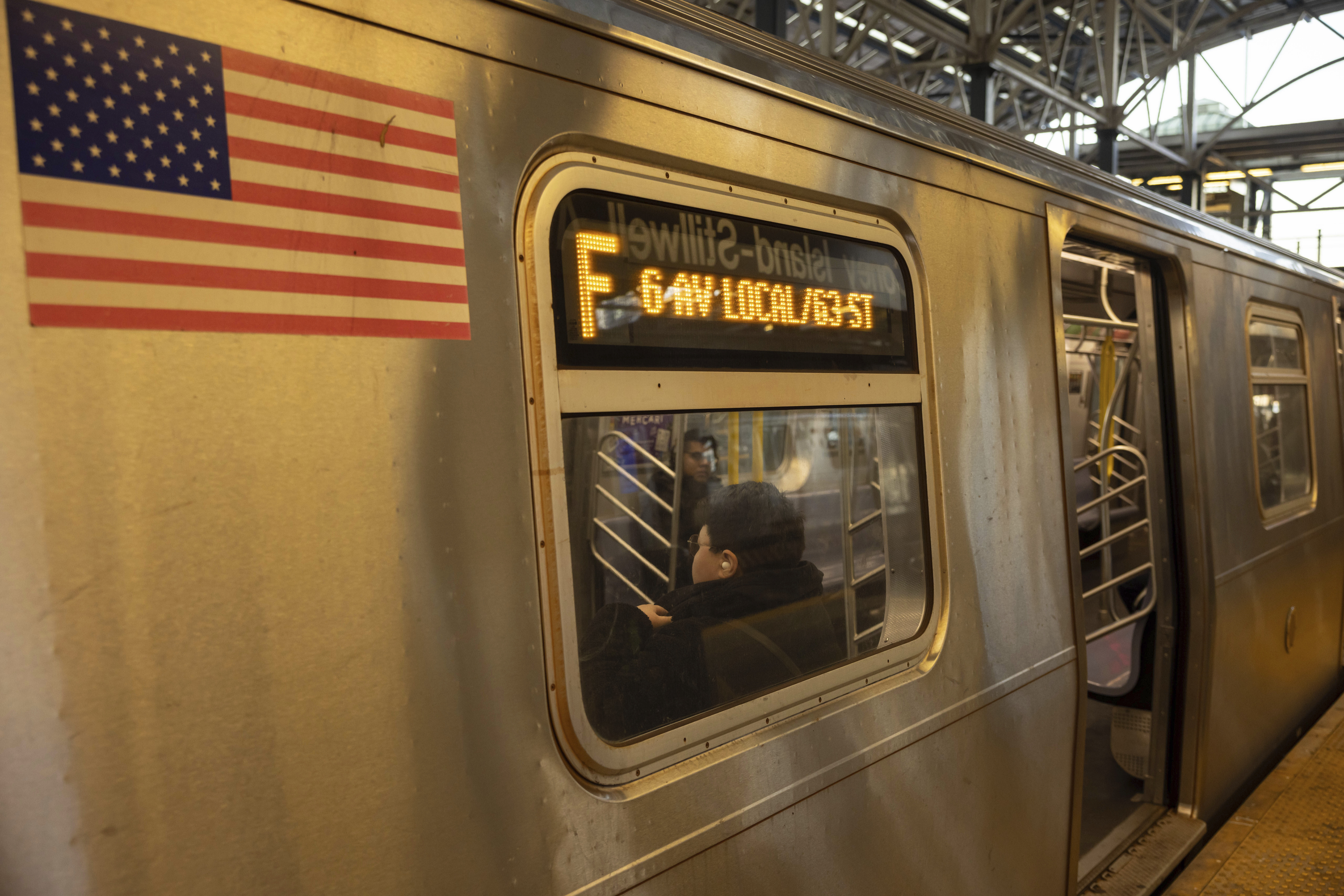 FILE - Commuters sit on the F train at the Coney Island-Stillwell Avenue Station, Thursday, Dec. 26, 2024, in New York. (AP Photo/Yuki Iwamura, File)