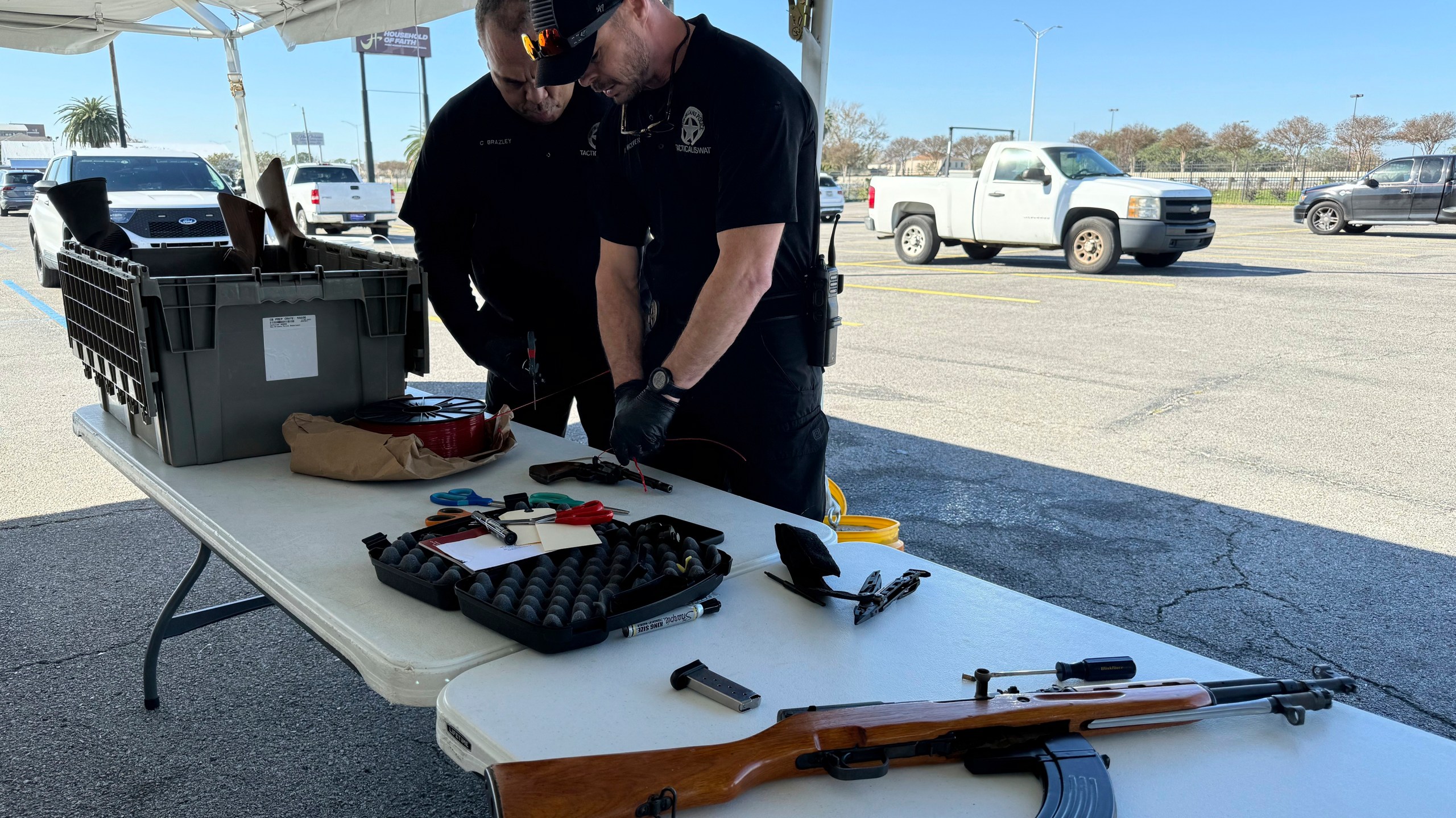 New Orleans police officers dismantle firearms handed over in exchange for PlayStations at a city-supported gun buyback Tuesday, Dec. 31, 2024, in New Orleans. (AP Photo/Jack Brook)