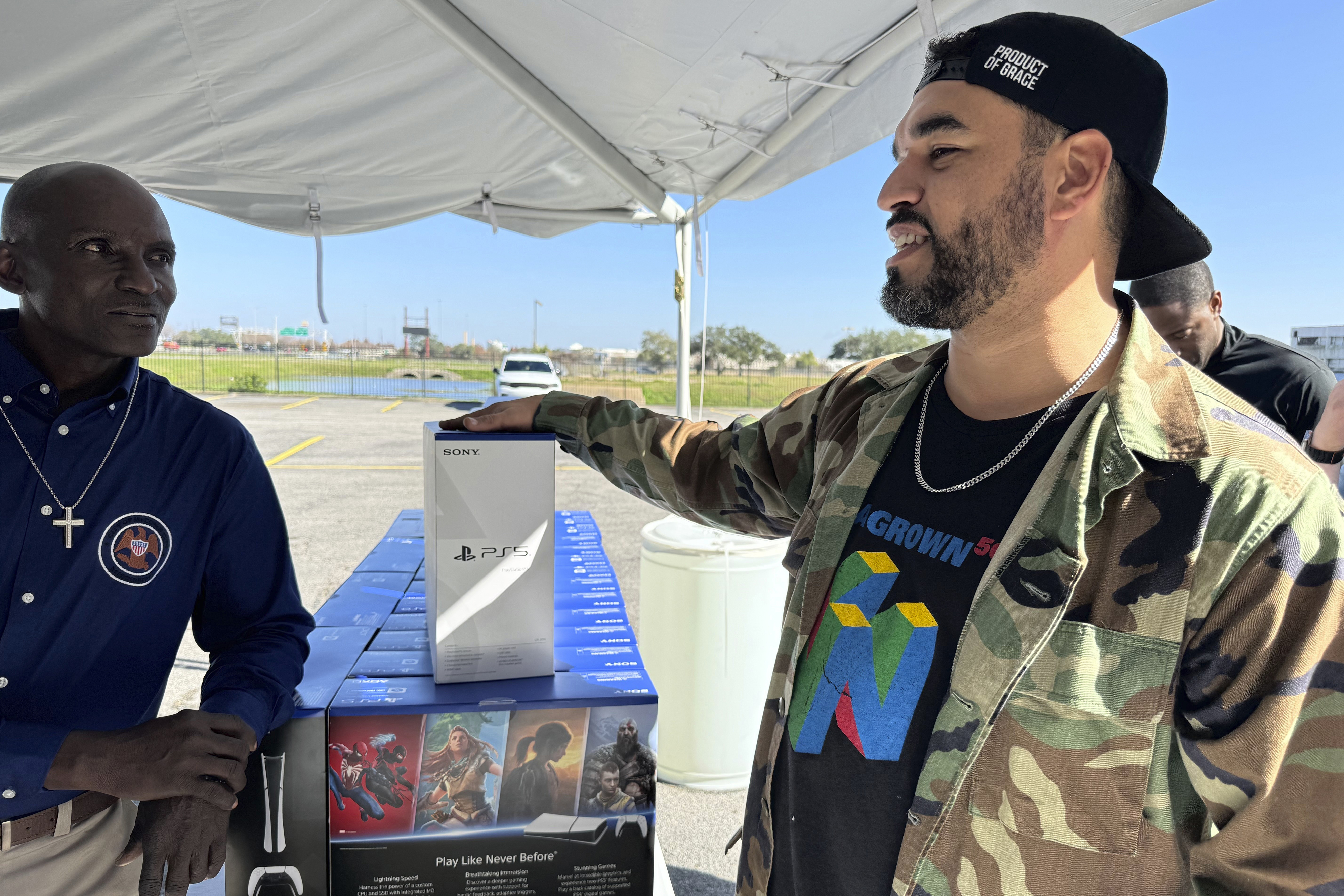 J.D. Carrere, co-director of the NOLA Grown gaming program, right, attends a city-supported gun buyback program Tuesday, Dec. 31, 2024, in New Orleans. Carrere has helped organize a series of gun buybacks after Louisiana loosened gun ownership restrictions. (AP Photo/Jack Brook)