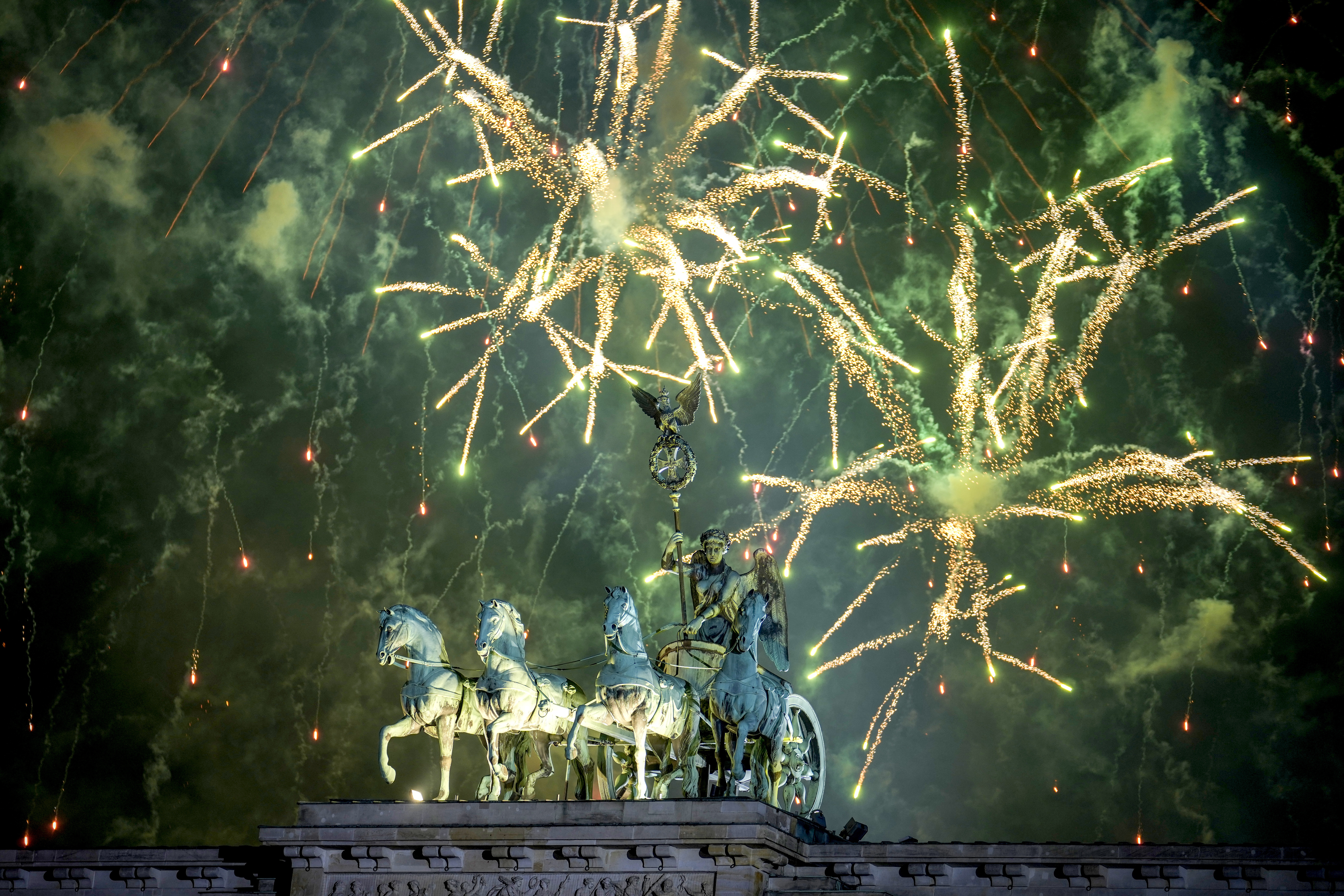 Fireworks light the sky above the Quadriga at the Brandenburg Gate during New Year's celebrations shortly after midnight in Berlin, Germany, Wednesday, Jan. 1, 2025. (AP Photo/Ebrahim Noroozi)