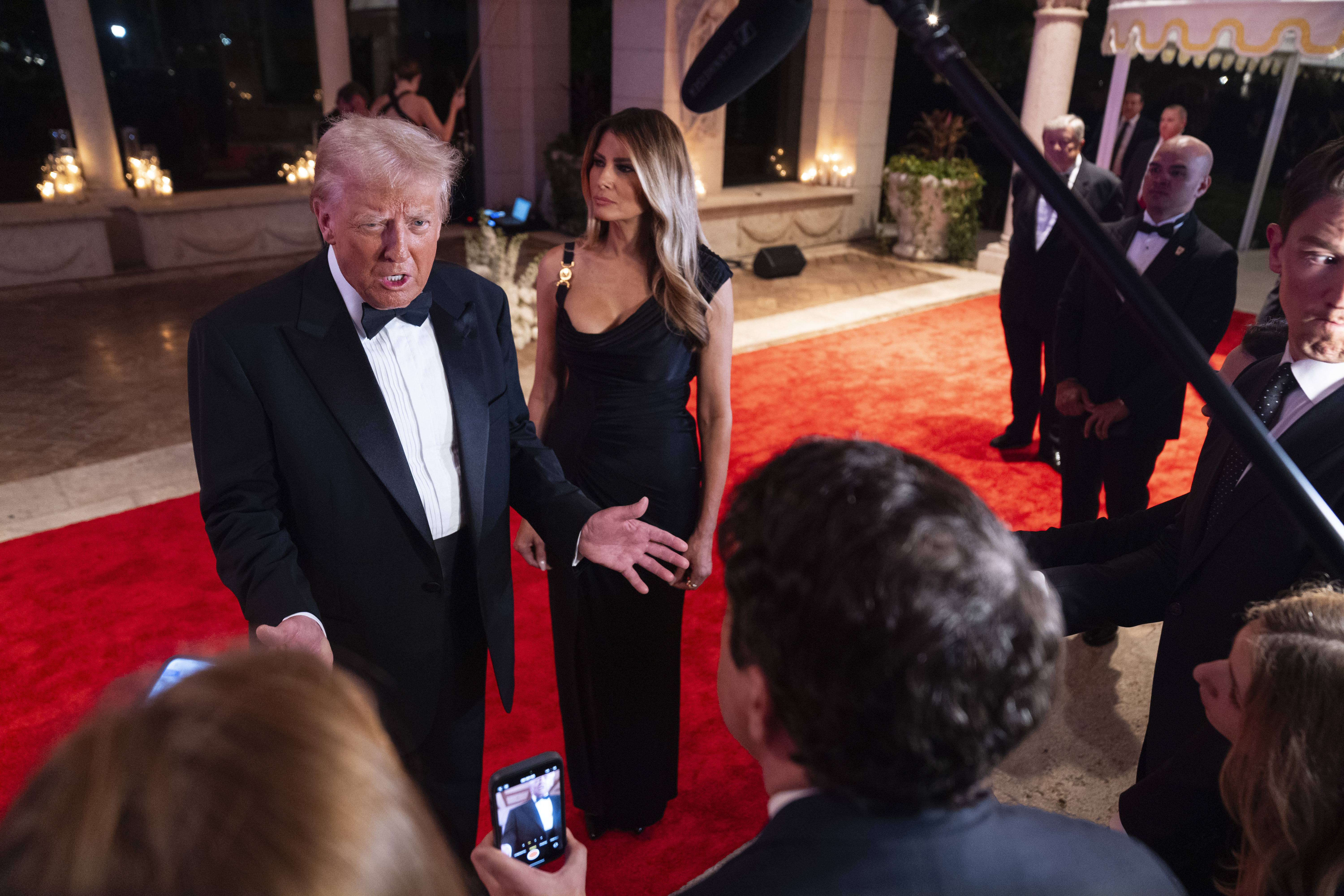 Melania Trump looks on as President-elect Donald Trump speaks to reporters before a New Year's Eve party at Mar-a-Lago, Tuesday, Dec. 31, 2024, in Palm Beach, Fla. (AP Photo/Evan Vucci)