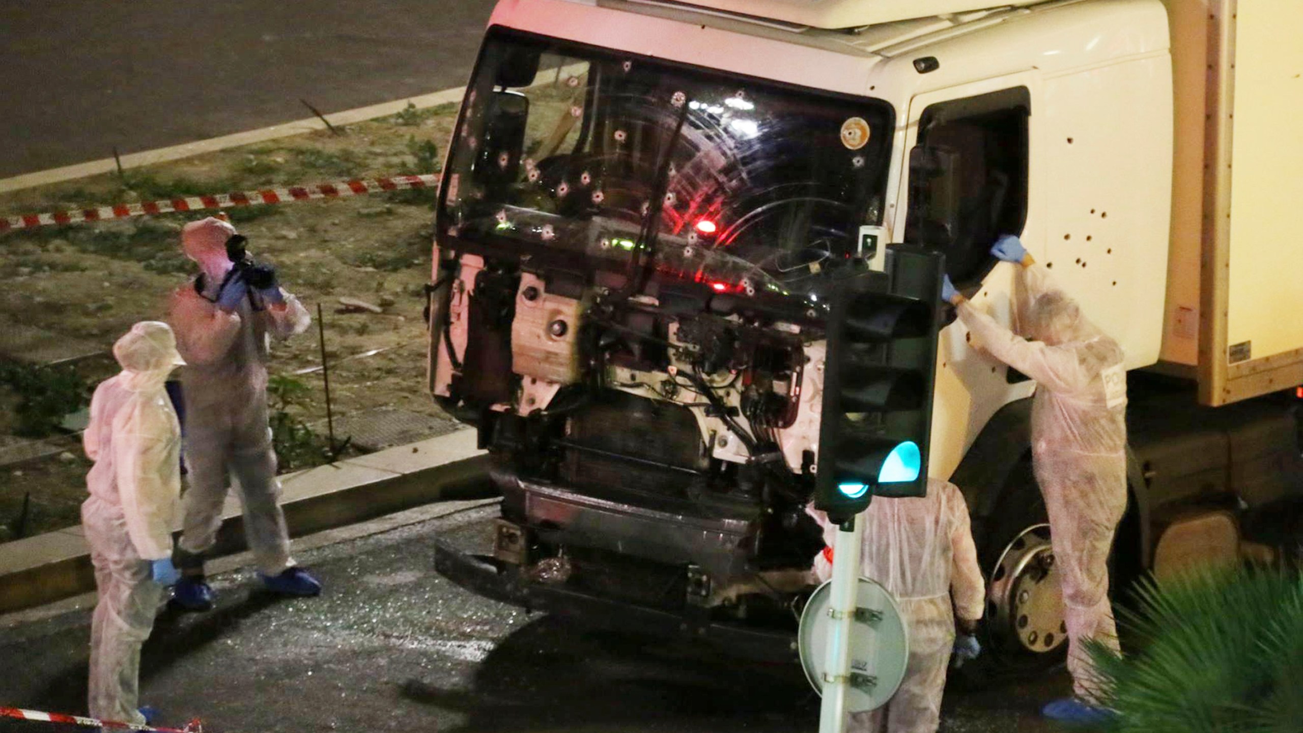 FILE - In this July 14, 2016 file photo, authorities investigate a truck after it plowed through Bastille Day revelers in the French resort city of Nice, France, killing 86 people. (Sasha Goldsmith via AP, File)