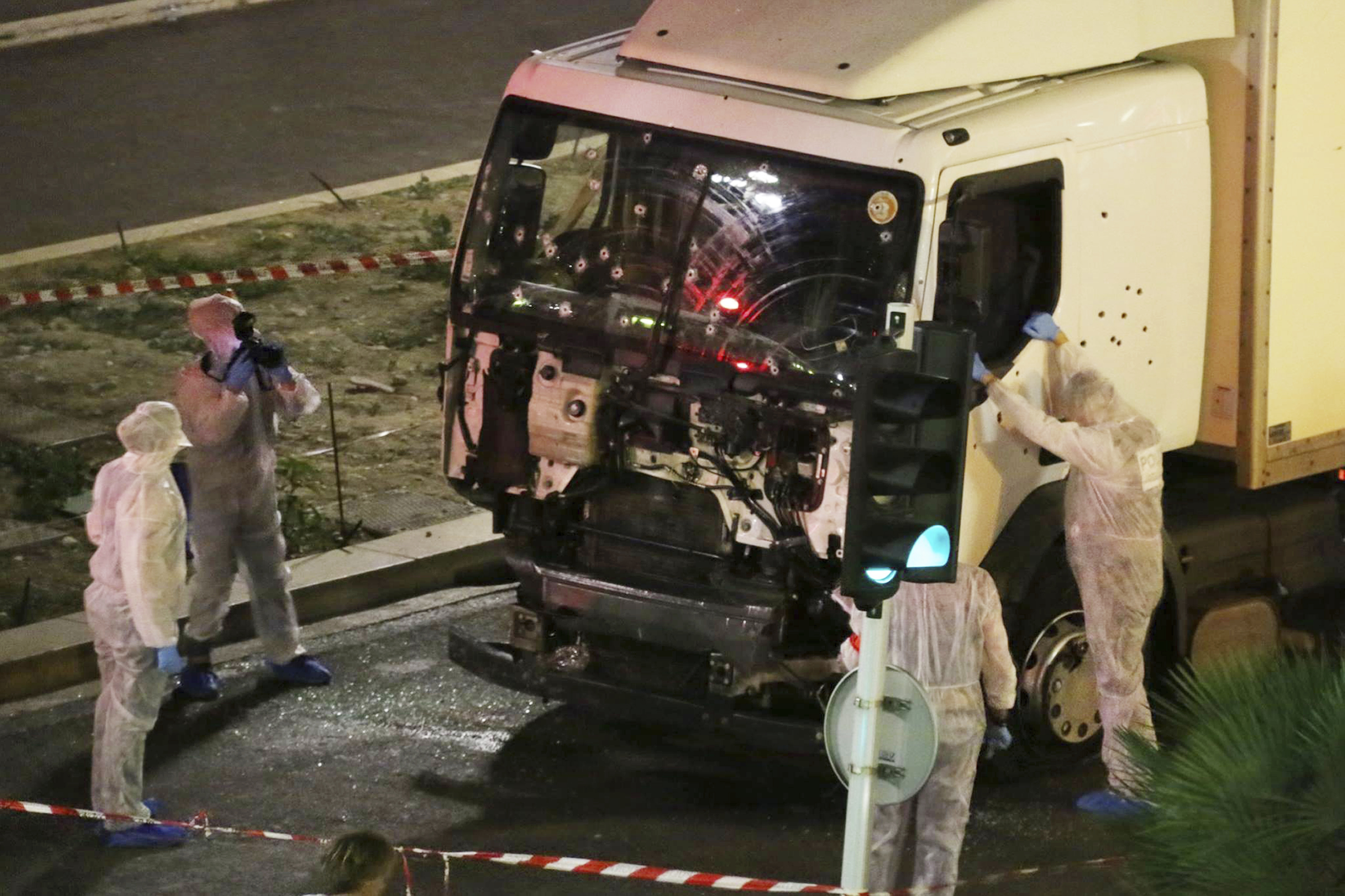 FILE - In this July 14, 2016 file photo, authorities investigate a truck after it plowed through Bastille Day revelers in the French resort city of Nice, France, killing 86 people. (Sasha Goldsmith via AP, File)