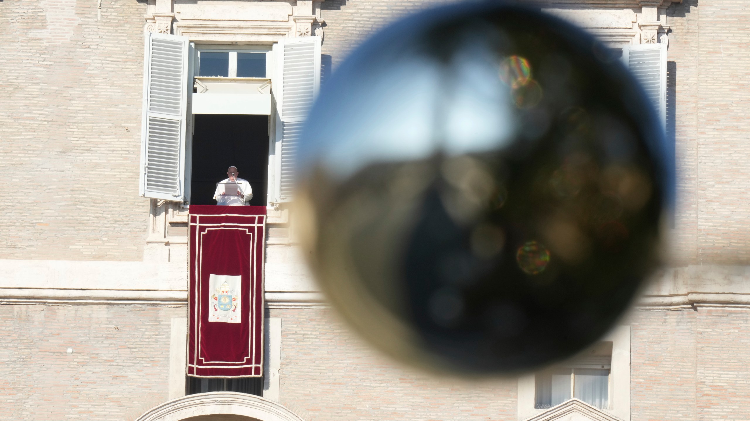 Pope Francis appears at his studio's window overlooking St. Peter's Square at The Vatican to bless pilgrims and faithful after presiding over a mass in St. Peter's Basilica on New Year's Day, Wednesday, Jan. 1, 2025. (AP Photo/Andrew Medichini)