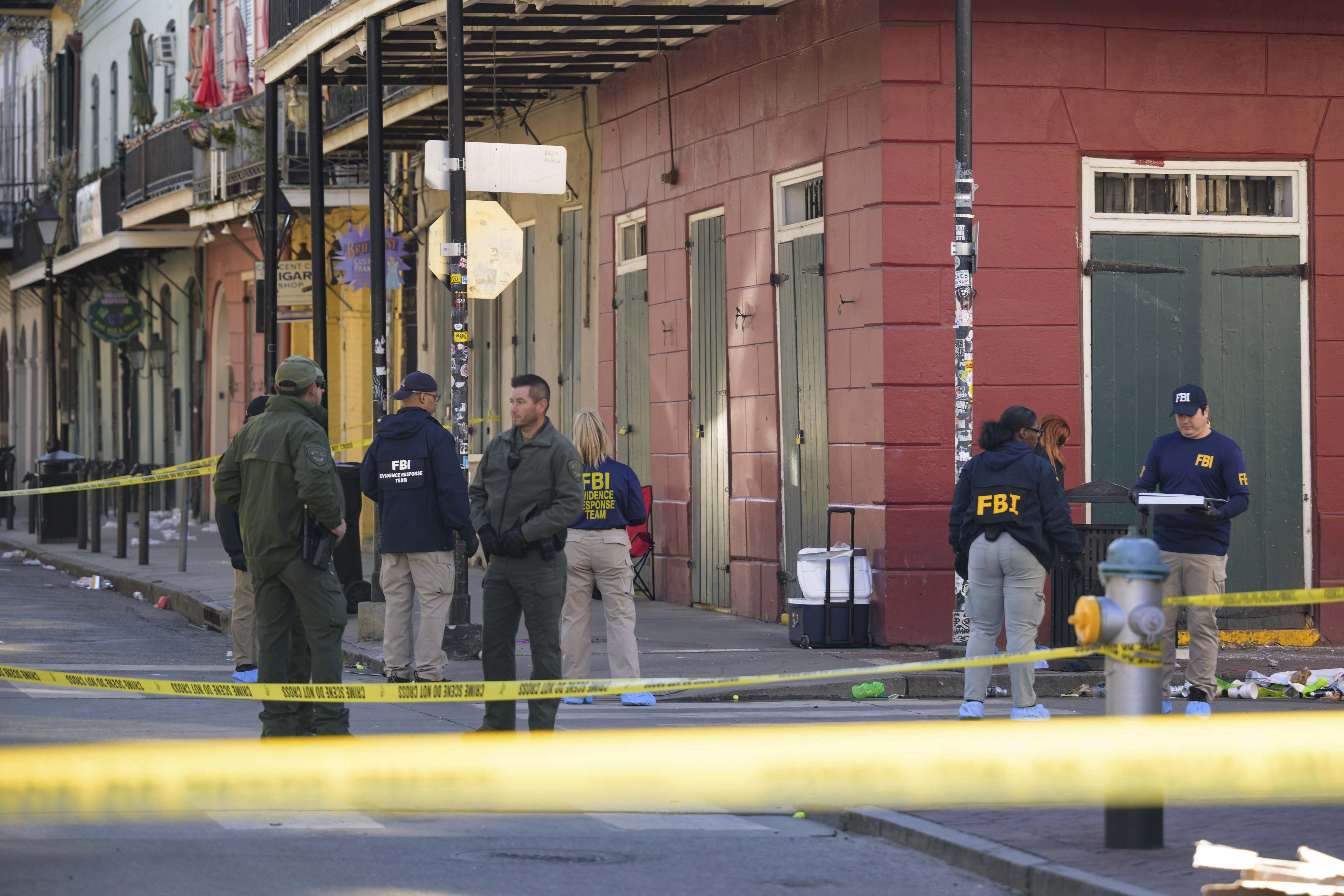 The FBI investigates the area on Orleans St and Bourbon Street by St. Louis Cathedral in the French Quarter where a suspicious package was detonated after a person drove a truck into a crowd earlier on Bourbon Street on Wednesday, Jan. 1, 2025. (AP Photo/Matthew Hinton)