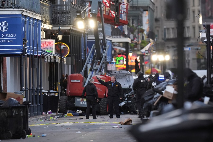 EDS NOTE: GRAPHIC CONTENT - Emergency personnel work the scene on Bourbon Street after a vehicle drove into a crowd on New Orleans' Canal and Bourbon Street, Wednesday Jan. 1, 2025. (AP Photo/Gerald Herbert)