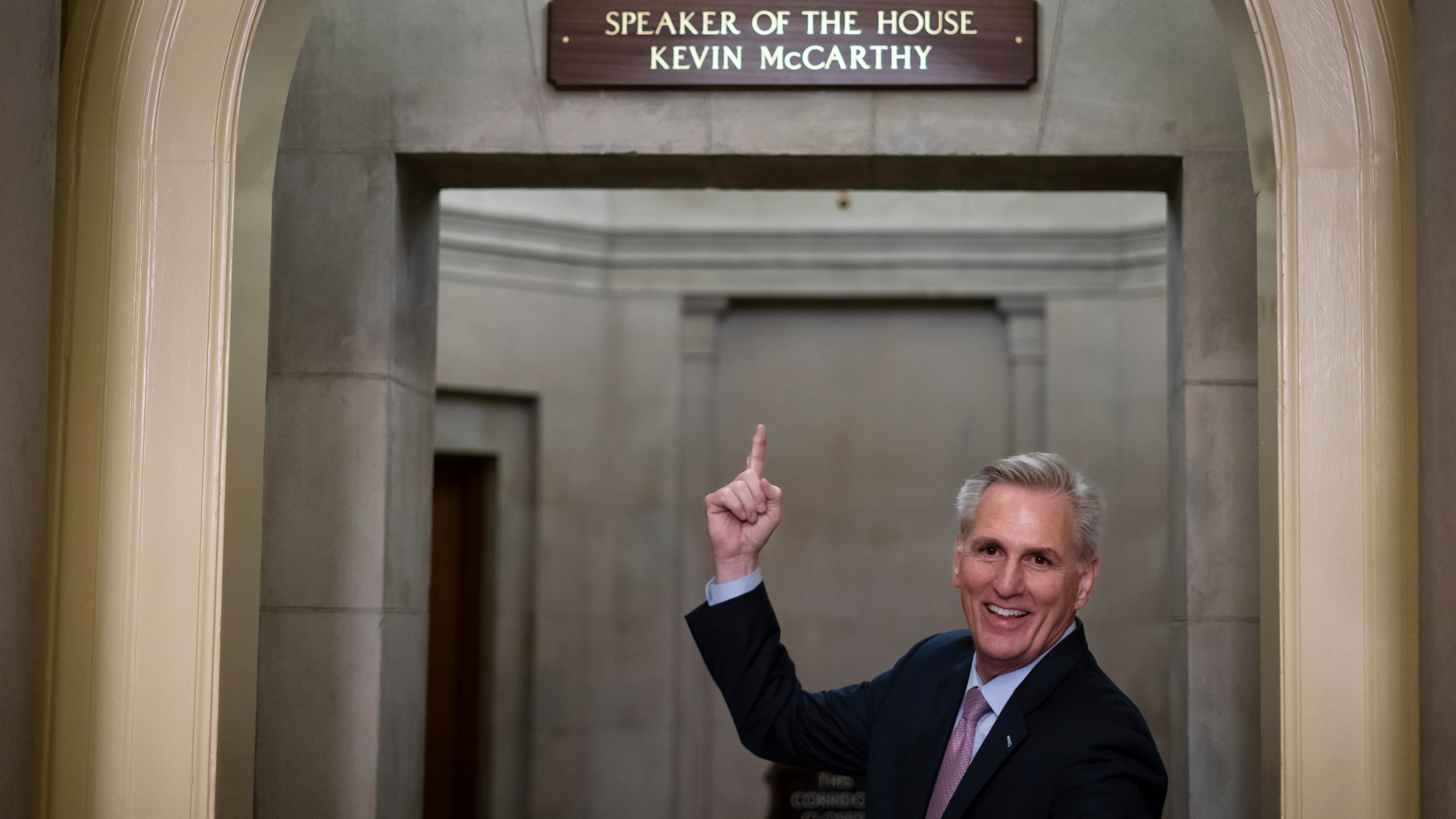 FILE - Then-House Speaker Kevin McCarthy of Calif., gestures towards the newly installed nameplate at his office after he was sworn in as speaker of the 118th Congress in Washington, early Saturday, Jan. 7, 2023. (AP Photo/ Matt Rourke, File)