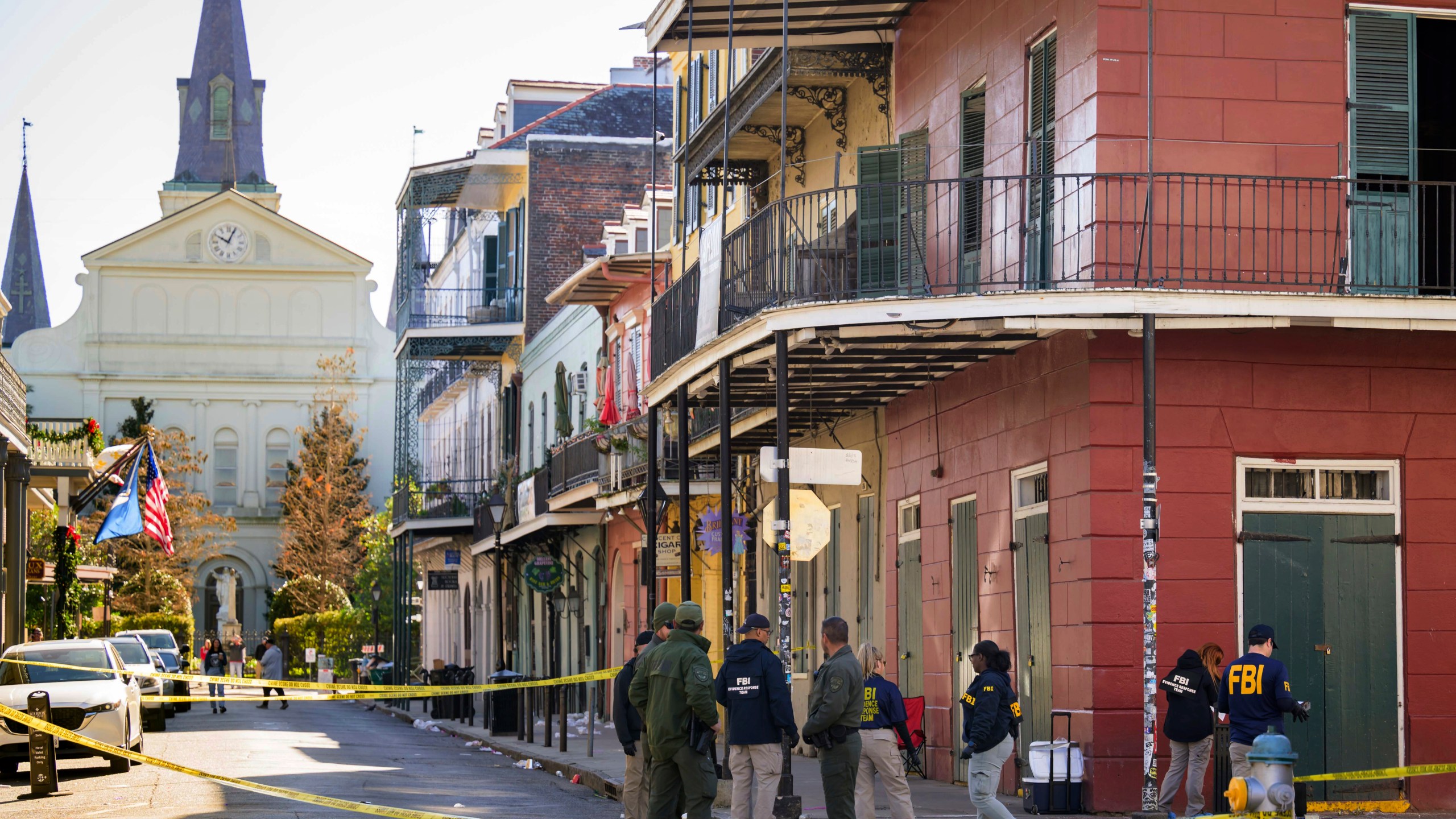 The FBI investigates the area on Orleans St and Bourbon Street by St. Louis Cathedral in the French Quarter where a suspicious package was detonated after a person drove a truck into a crowd earlier on Bourbon Street on Wednesday, Jan. 1, 2025. (AP Photo/Matthew Hinton)