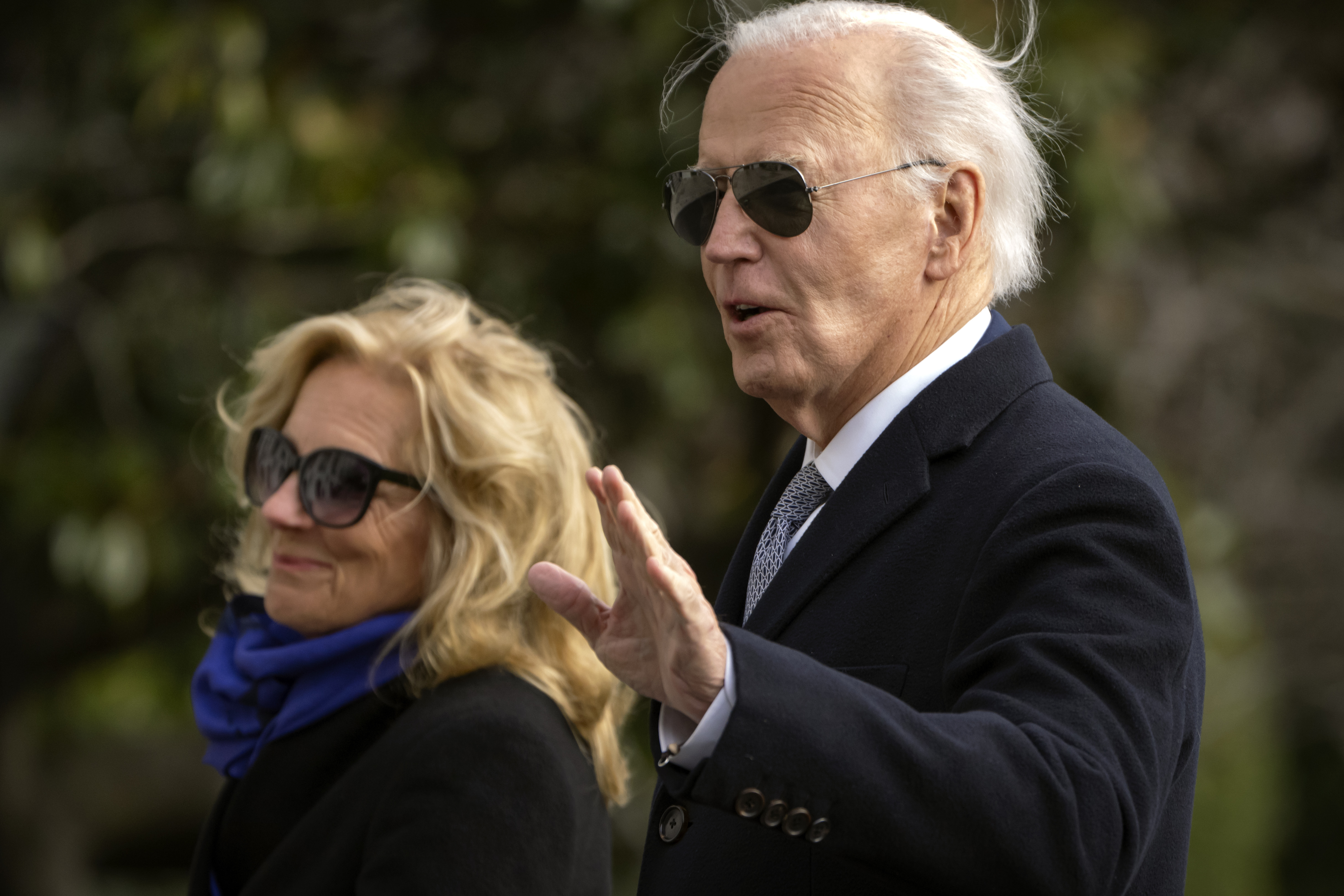 President Joe Biden gestures as he and first lady Jill Biden walk across the South Lawn of the White House, Thursday, Jan. 2, 2025, in Washington, after returning from Camp David. (AP Photo/Mark Schiefelbein)