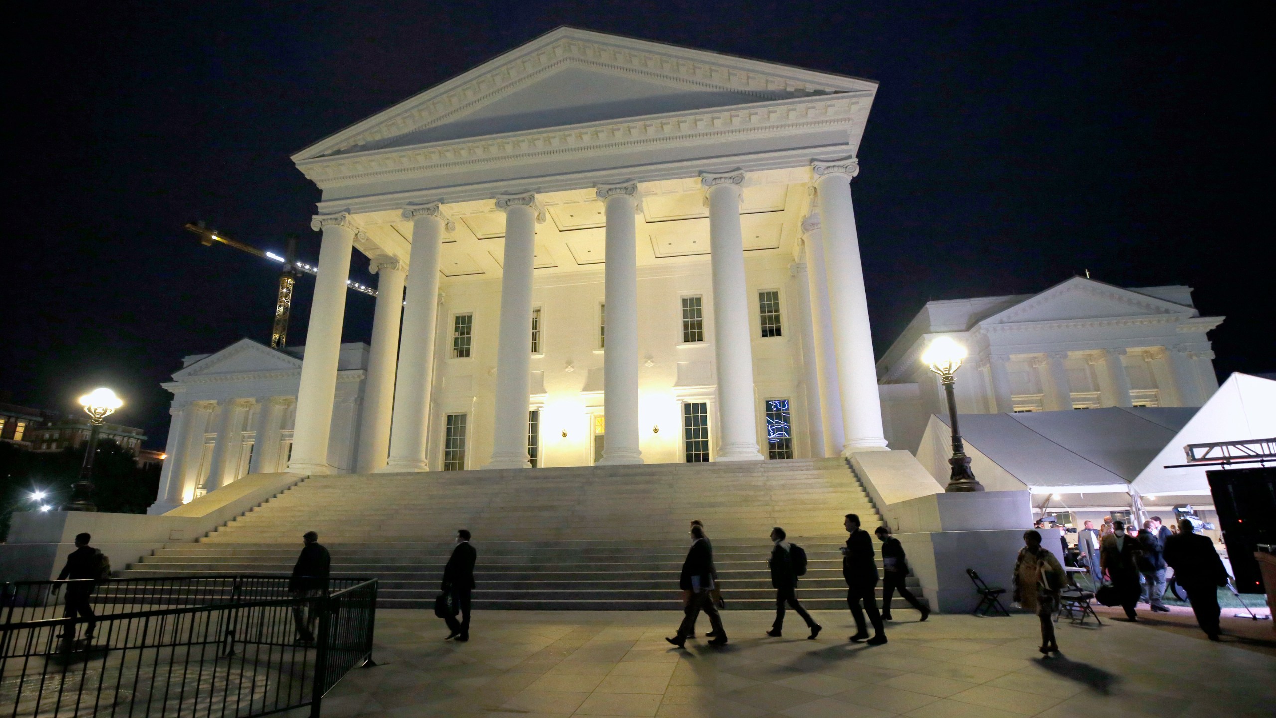 FILE - House of Delegates members walk past the south portico at the Virginia State Capitol in Richmond, Va., Wednesday, April 22, 2020. (Bob Brown/Richmond Times-Dispatch via AP, Pool, File)