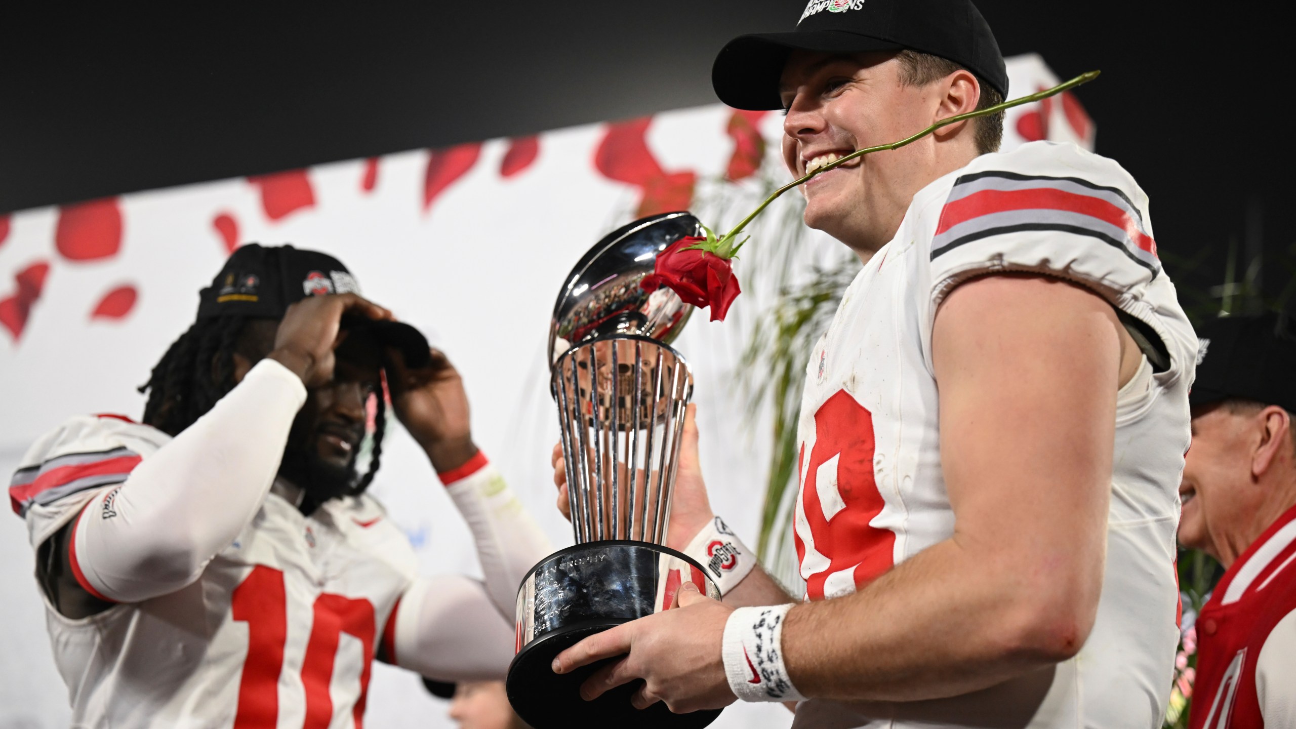 Ohio State quarterback Will Howard (18) celebrates with the trophy after the quarterfinals of the Rose Bowl College Football Playoff against Oregon, Wednesday, Jan. 1, 2025, in Pasadena, Calif. (AP Photo/Kyusung Gong)