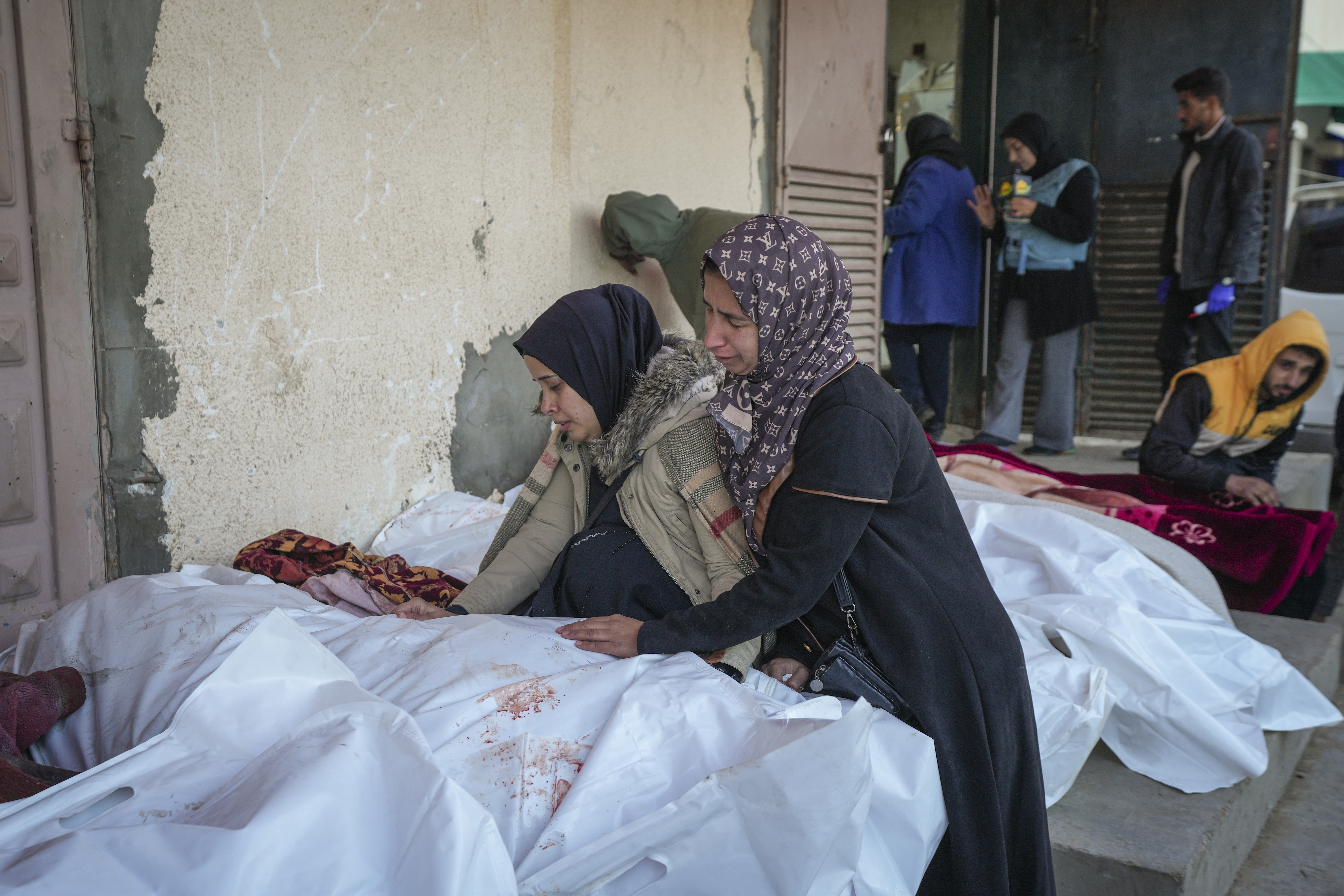 Relatives mourn over the bodies of victims of overnight Israeli army strikes at multiple locations in central Gaza Strip, at Al-Aqsa Martyrs Hospital in Deir al-Balah, Friday, Jan. 3, 2025. According to Al-Aqsa Martyrs Hospital, 30 people, including 10 women and 7 children, were killed in several attacks overnight in central Gaza. (AP Photo/Abdel Kareem Hana)