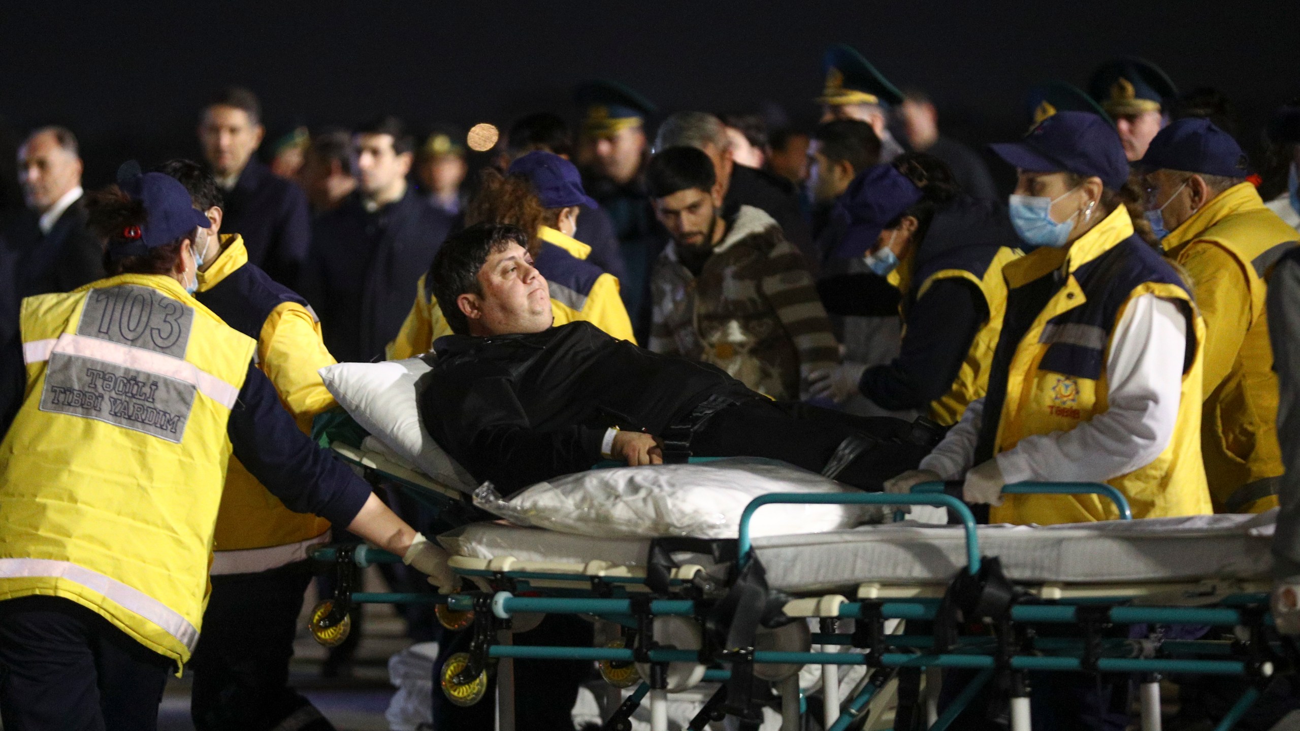 Wounded passengers of the Azerbaijani Airline's plane crashed near the Kazakhstani city of Aktau, are transported from a medical plane at the Heydar Aliyev International Airport outside Baku, Azerbaijan, Thursday, Dec. 26, 2024. (AP Photo)