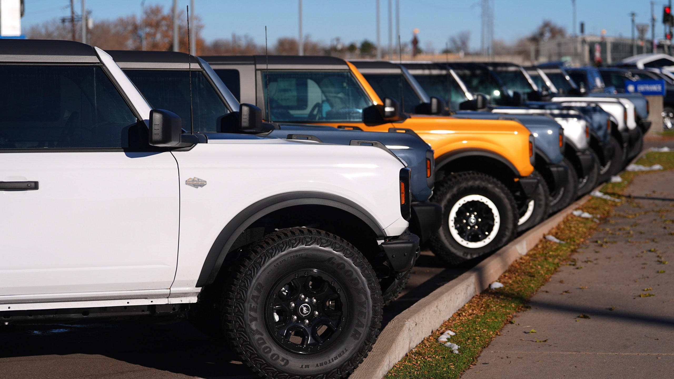 FILE - A long line of unsold 2024 Bronco utility vehicles sit on display at Ford dealership on Nov. 28, 2024, in southeast Denver. (AP Photo/David Zalubowski, File)