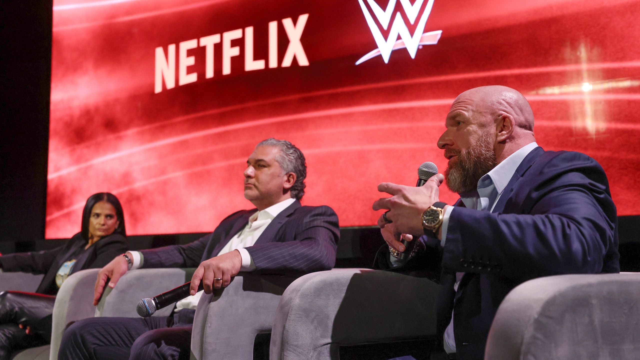 From left, Netflix Chief Content Officer Bela Bajaria, WWE President Nick Khan and WWE Chief Content Officer Paul "Triple H" Levesque discuss the World Wrestling Entertainment and Netflix during an event at Netflix's headquarters in Los Angeles on Dec. 3, 2024. (Meg Oliphant/WWE/Netflix via AP)