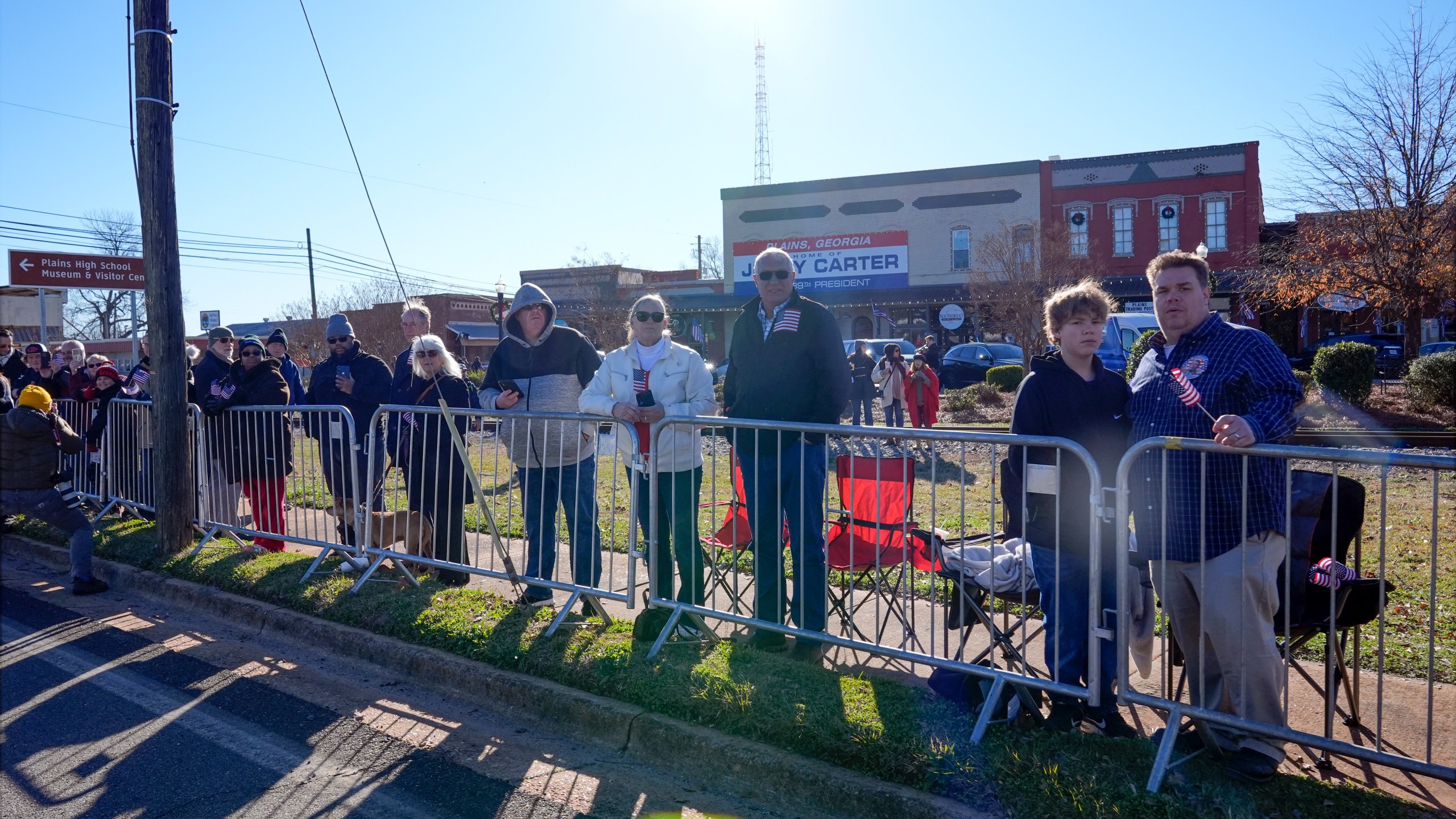 People line the street in Plains, Ga., before the hearse carrying the casket of former President Jimmy Carter passes through the town Saturday, Jan. 4, 2025. Carter died Dec. 29 at the age of 100. (AP Photo/Alex Brandon, Pool)