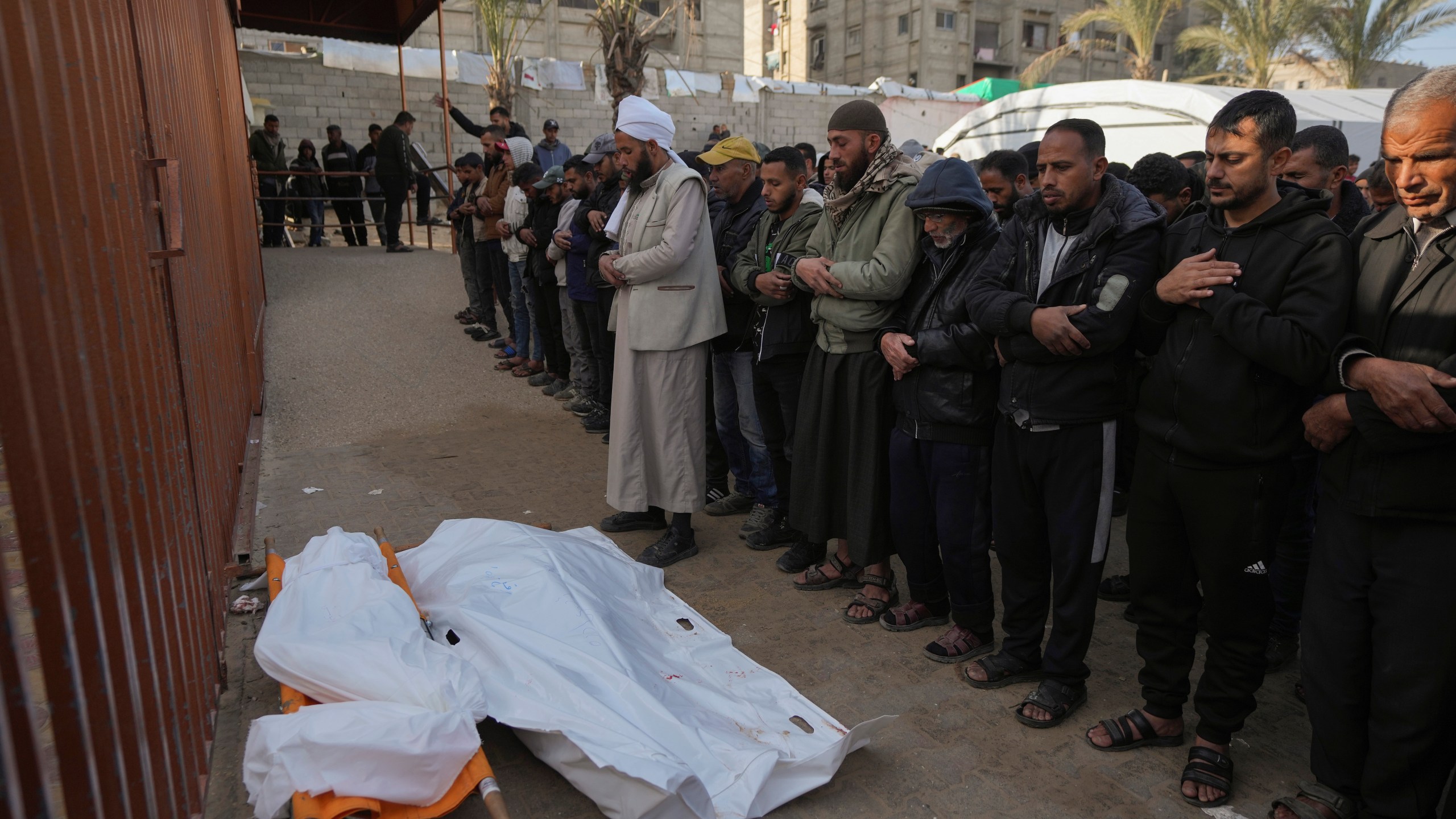 Palestinians attend funeral prayers for two of the ten people killed in overnight Israeli airstrikes on the Khan Younis refugee camp, southern Gaza Strip, Saturday, Jan. 4, 2025. (AP Photo/Abdel Kareem Hana)