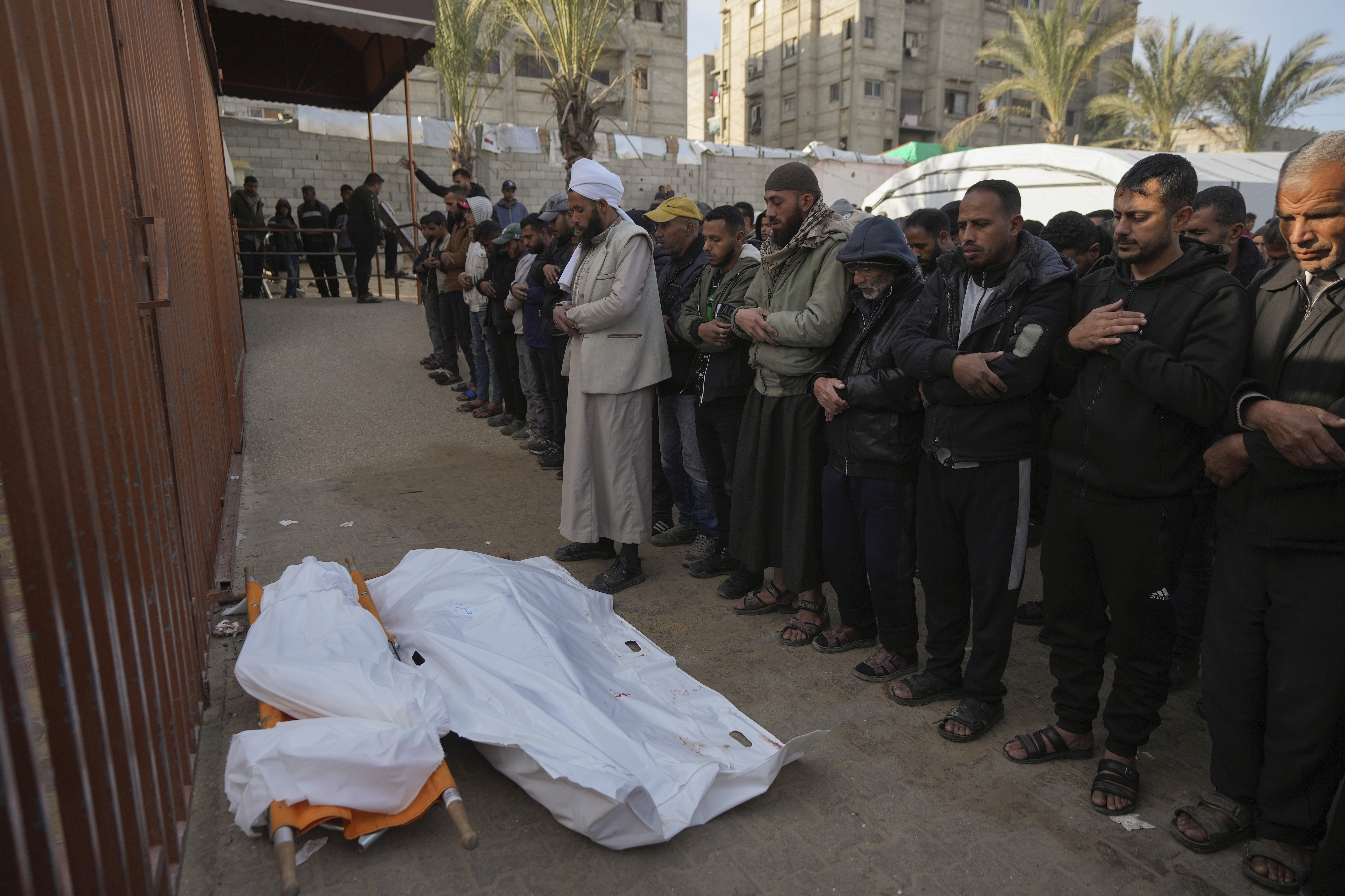 Palestinians attend funeral prayers for two of the ten people killed in overnight Israeli airstrikes on the Khan Younis refugee camp, southern Gaza Strip, Saturday, Jan. 4, 2025. (AP Photo/Abdel Kareem Hana)