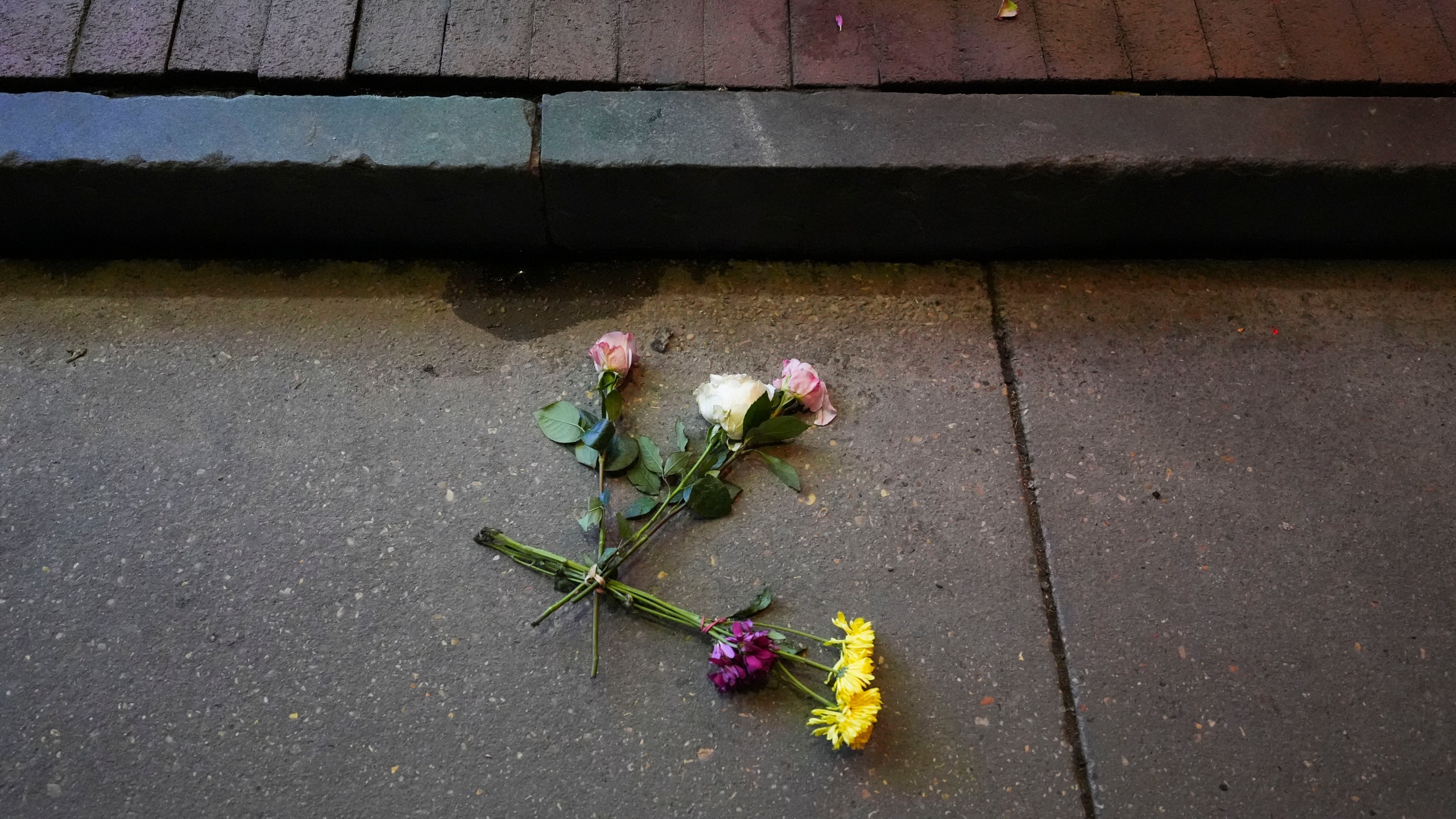 Flowers lie in the street at the site of a deadly truck attack on New Year's Day in New Orleans, Friday, Jan. 3, 2025. (AP Photo/Gerald Herbert)