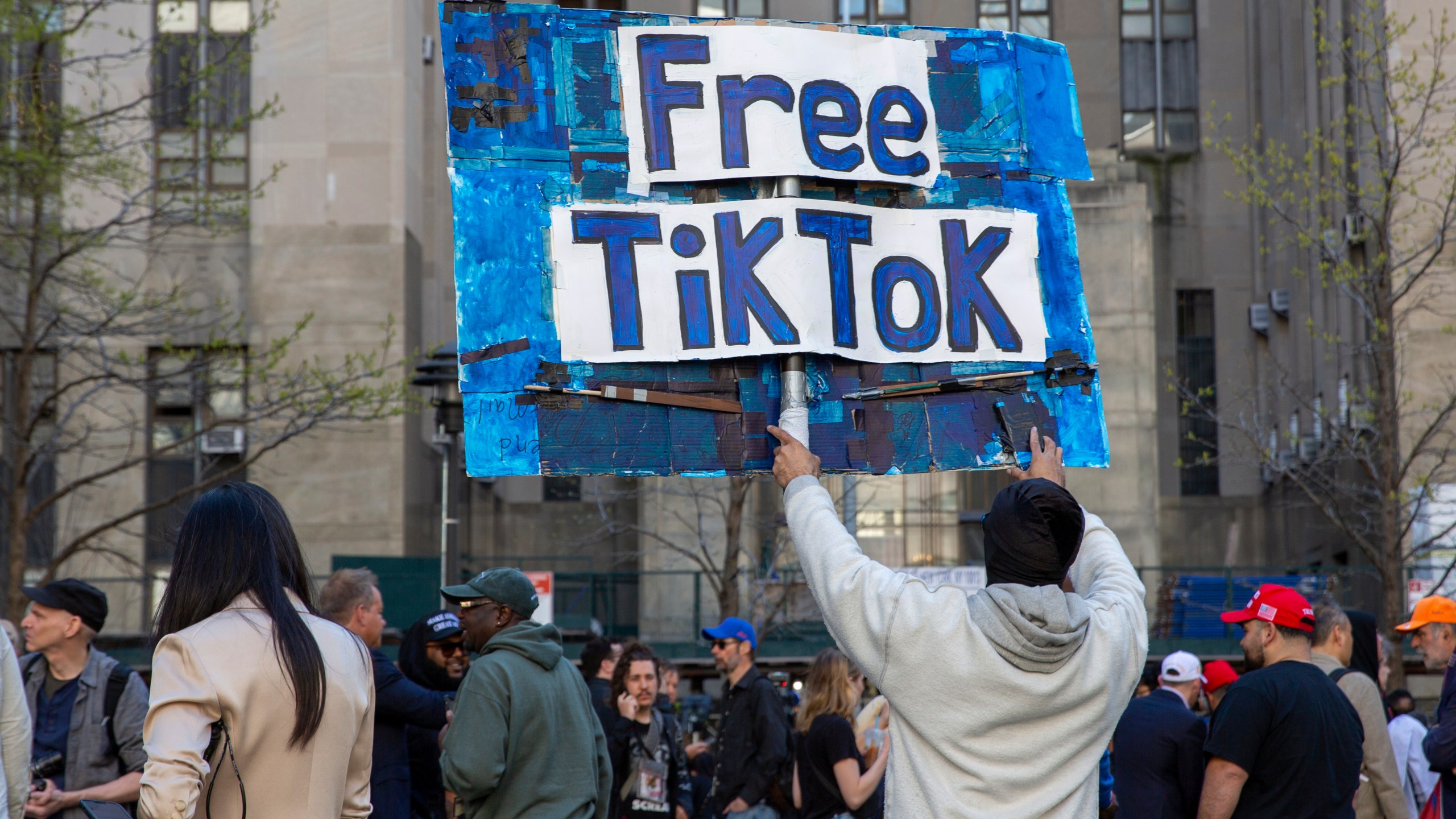 FILE - A man carries a Free TikTok sign in front of the courthouse where the hush-money trial of Donald Trump was underway on April 15, 2024, in New York. (AP Photo/Ted Shaffrey, File)