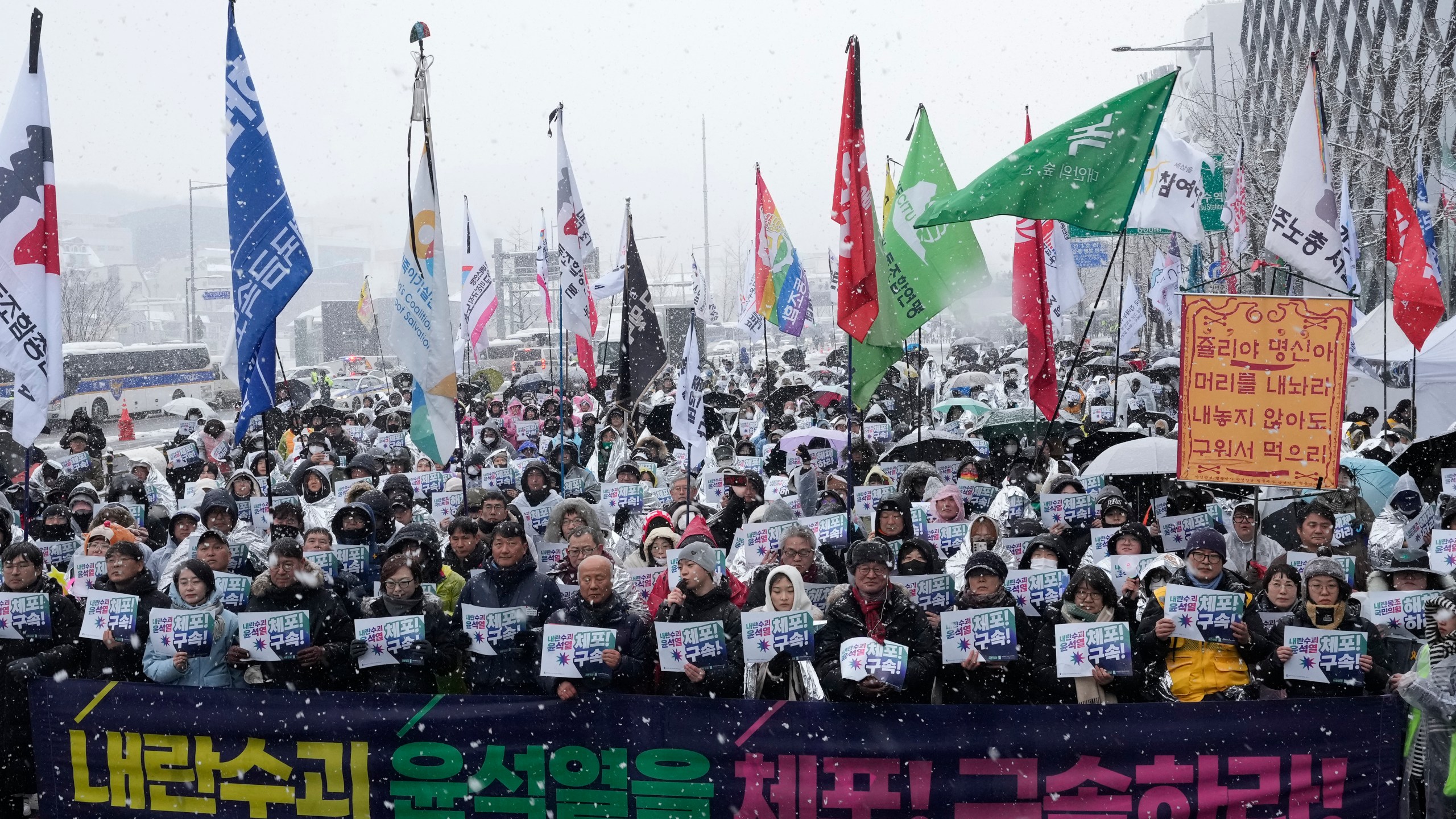 Protesters stage a rally demanding the arrest of impeached South Korean President Yoon Suk Yeol near the presidential residence in Seoul, South Korea, Sunday, Jan. 5, 2025. The letters read "Arrest Yoon Suk Yeol." (AP Photo/Ahn Young-joon)