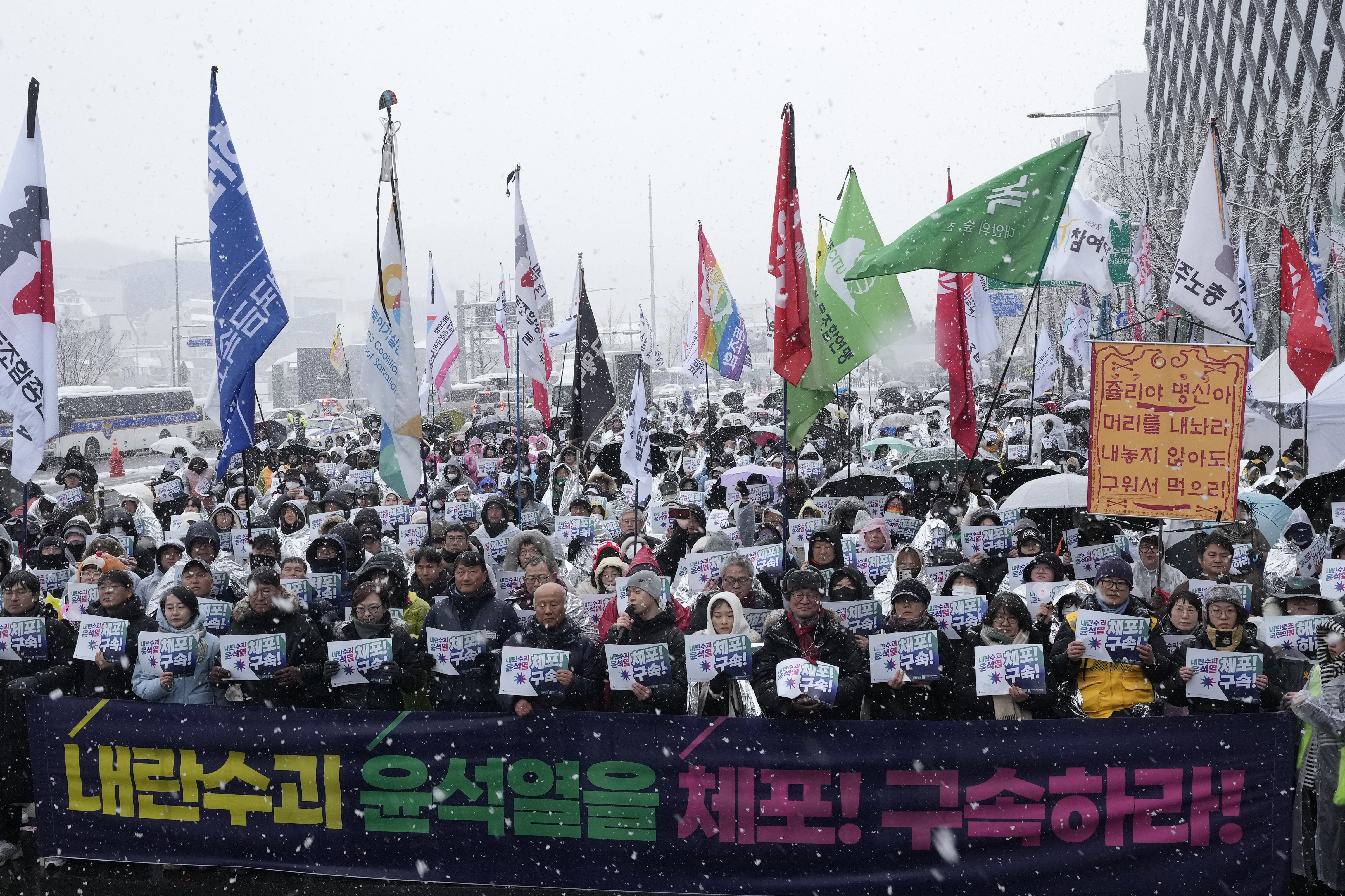 Protesters stage a rally demanding the arrest of impeached South Korean President Yoon Suk Yeol near the presidential residence in Seoul, South Korea, Sunday, Jan. 5, 2025. The letters read "Arrest Yoon Suk Yeol." (AP Photo/Ahn Young-joon)