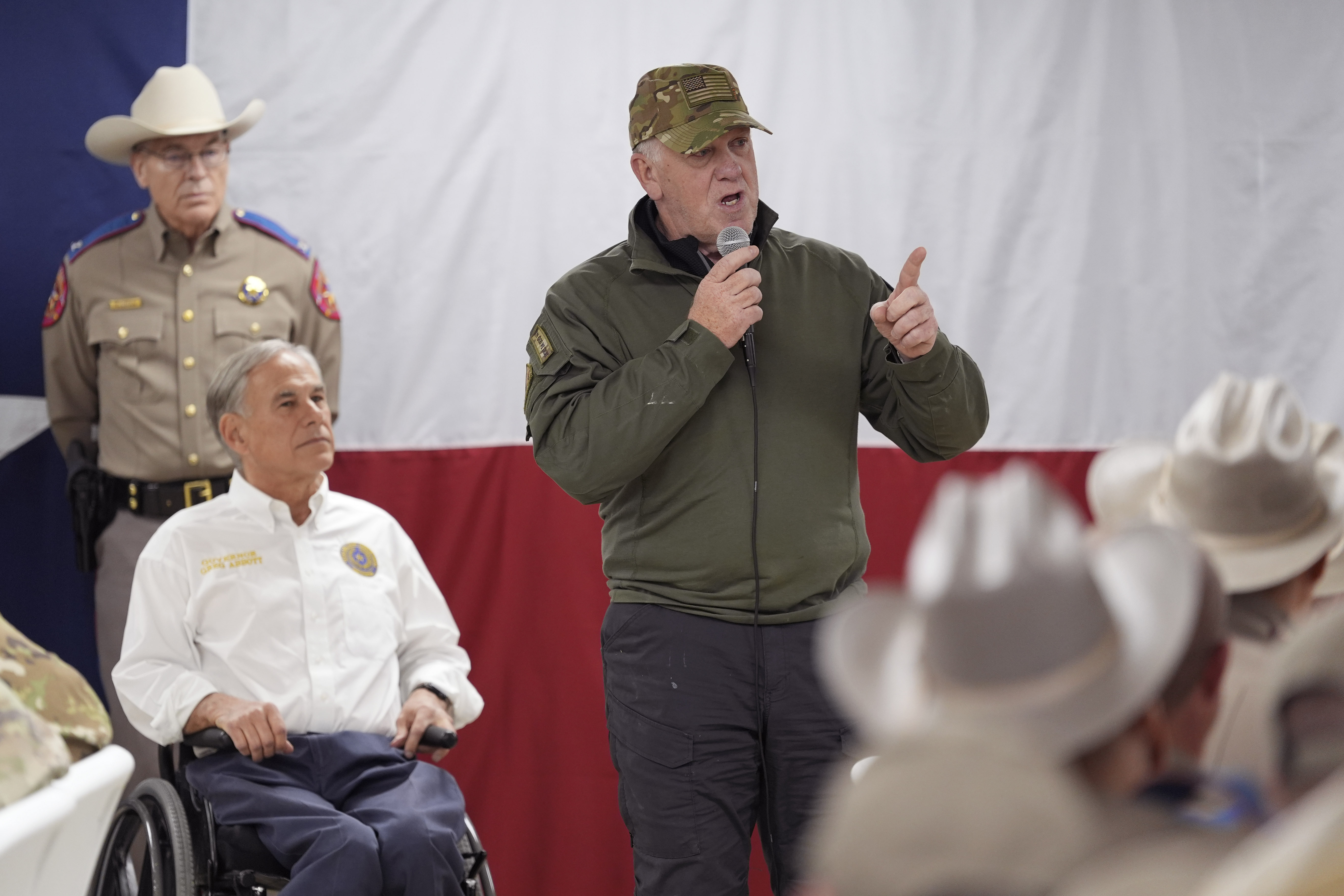 FILE - Incoming U.S. Border Czar Tom Homan, right, stands with Texas Gov. Greg Abbott, left, as he makes statements before serving meals to state troopers and national guardsmen taking part in Operation Lone Star at a facility on the U.S.-Mexico border on Nov. 26, 2024, in Eagle Pass, Texas. (AP Photo/Eric Gay, File)