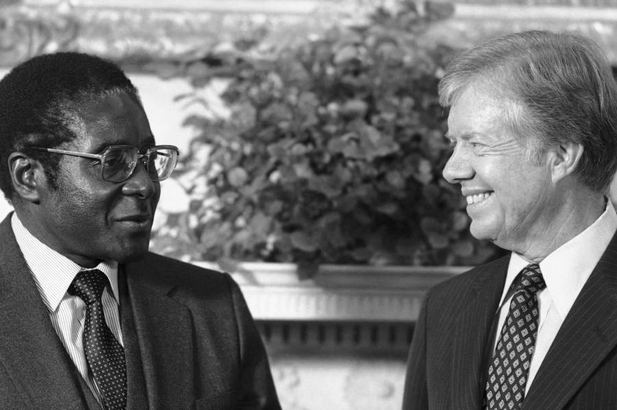 FILE - President Jimmy Carter meets with Zimbabwean Prime Minister Robert Mugabe in the Oval Office of the White House in Washington, Aug. 27, 1980. (AP Photo/Barry Thumma, File)