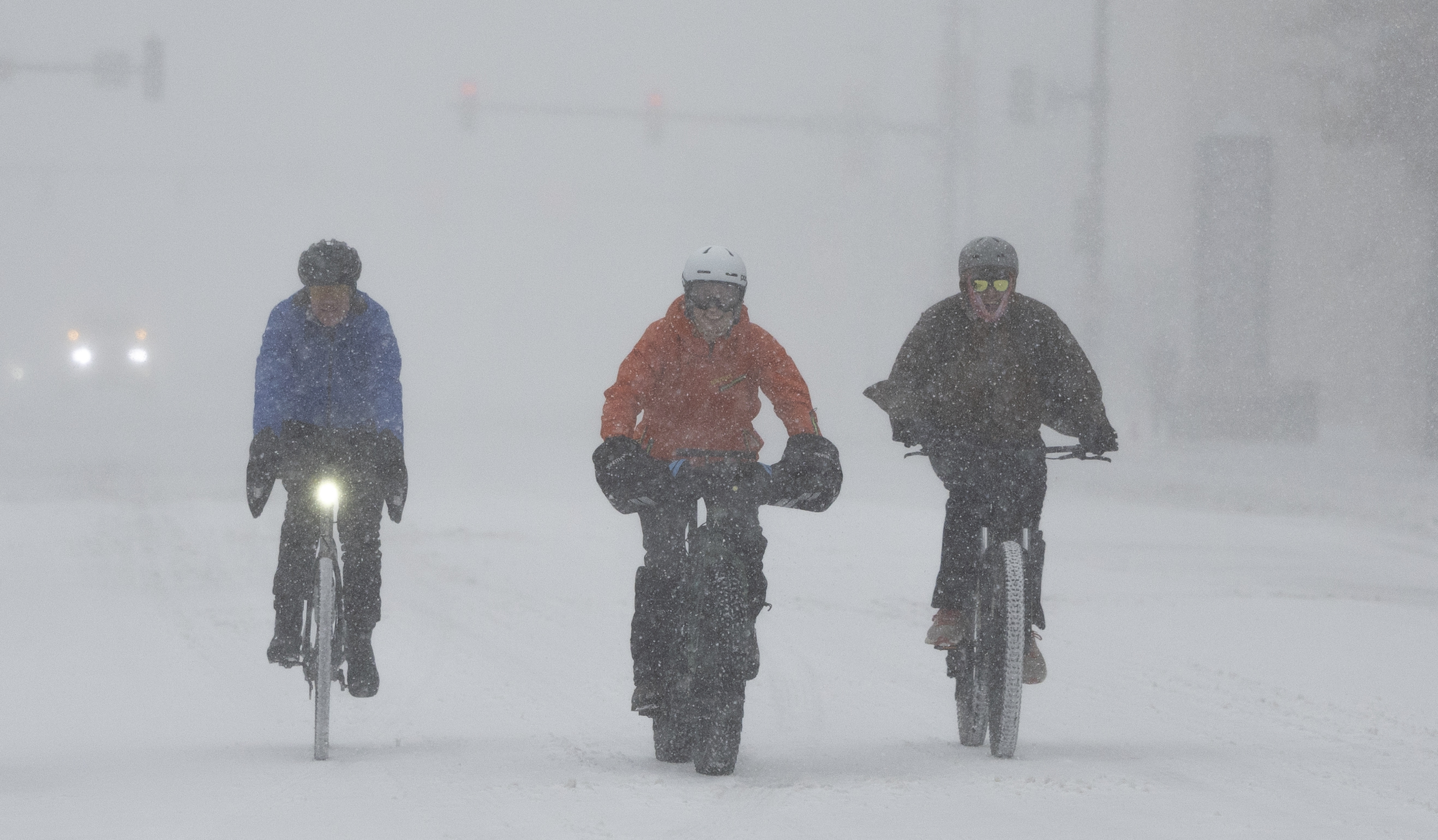 A group of cyclists make way through downtown Wichita, Kan., during a severe winter storm on Sunday, Jan. 5, 2025. (Travis Heying/The Wichita Eagle via AP)