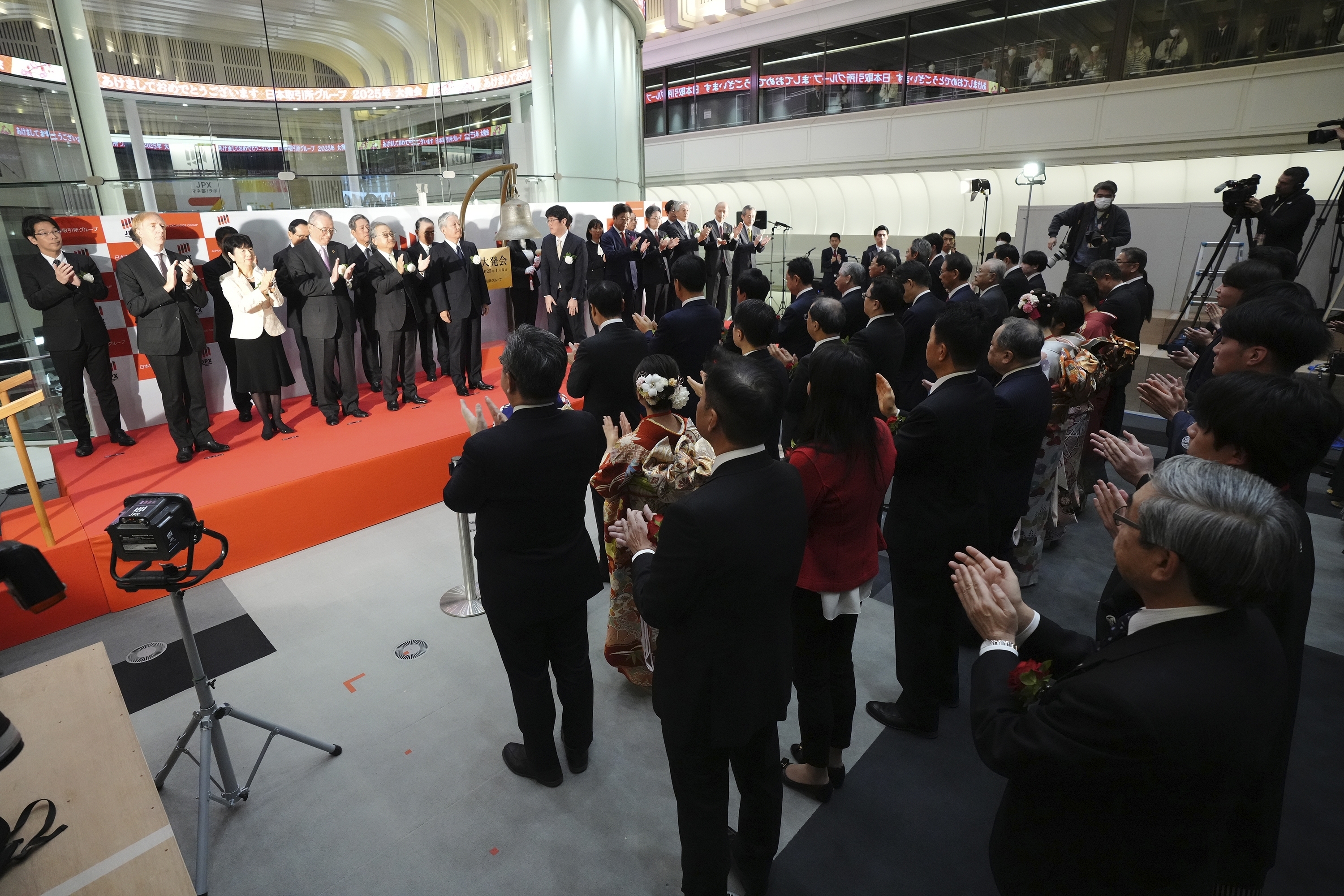 Staff of the Tokyo Stock Exchange and guests make a ceremonial hand-clapping during a ceremony marking the start of this year's trading Monday, Jan. 6, 2025, in Tokyo. (AP Photo/Eugene Hoshiko)