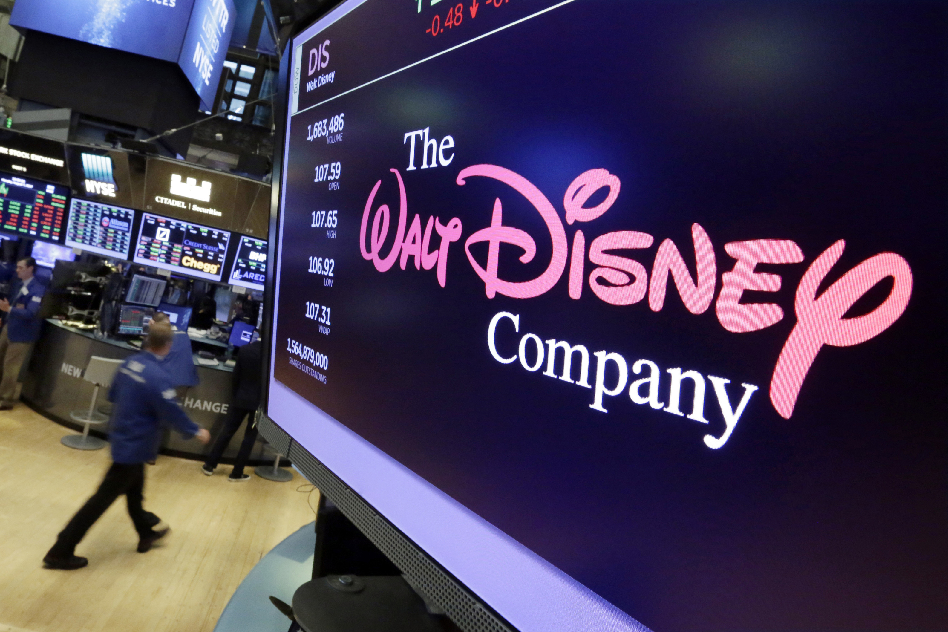 FILE - The Walt Disney Co. logo appears on a screen above the floor of the New York Stock Exchange, Aug. 8, 2017. (AP Photo/Richard Drew, File)