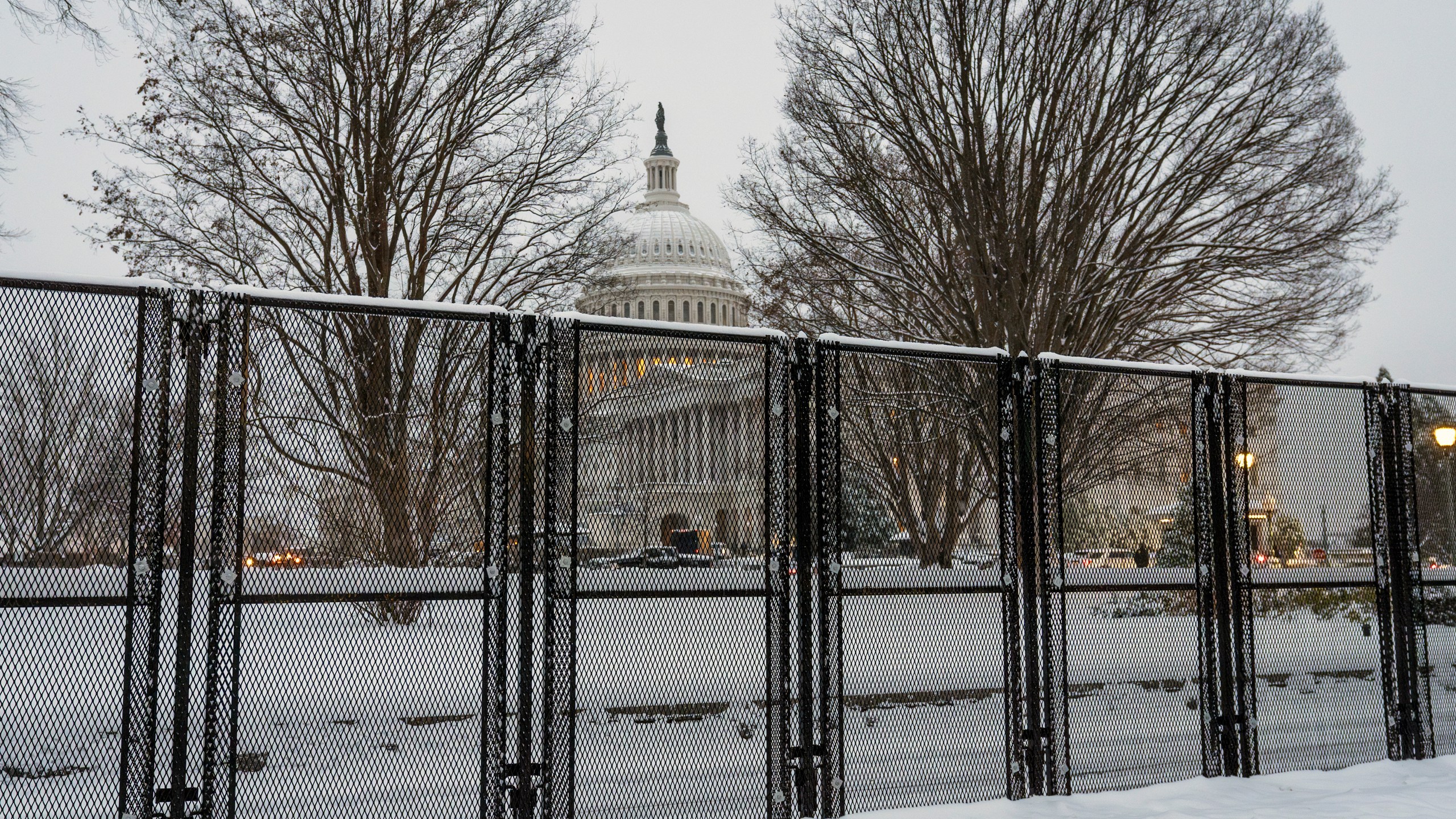 Security fencing surrounds Capitol Hill as snow blankets the region ahead of a joint session of Congress to certify the votes from the Electoral College in the presidential election, in Washington, Monday, Jan. 6, 2025. (AP Photo/J. Scott Applewhite)