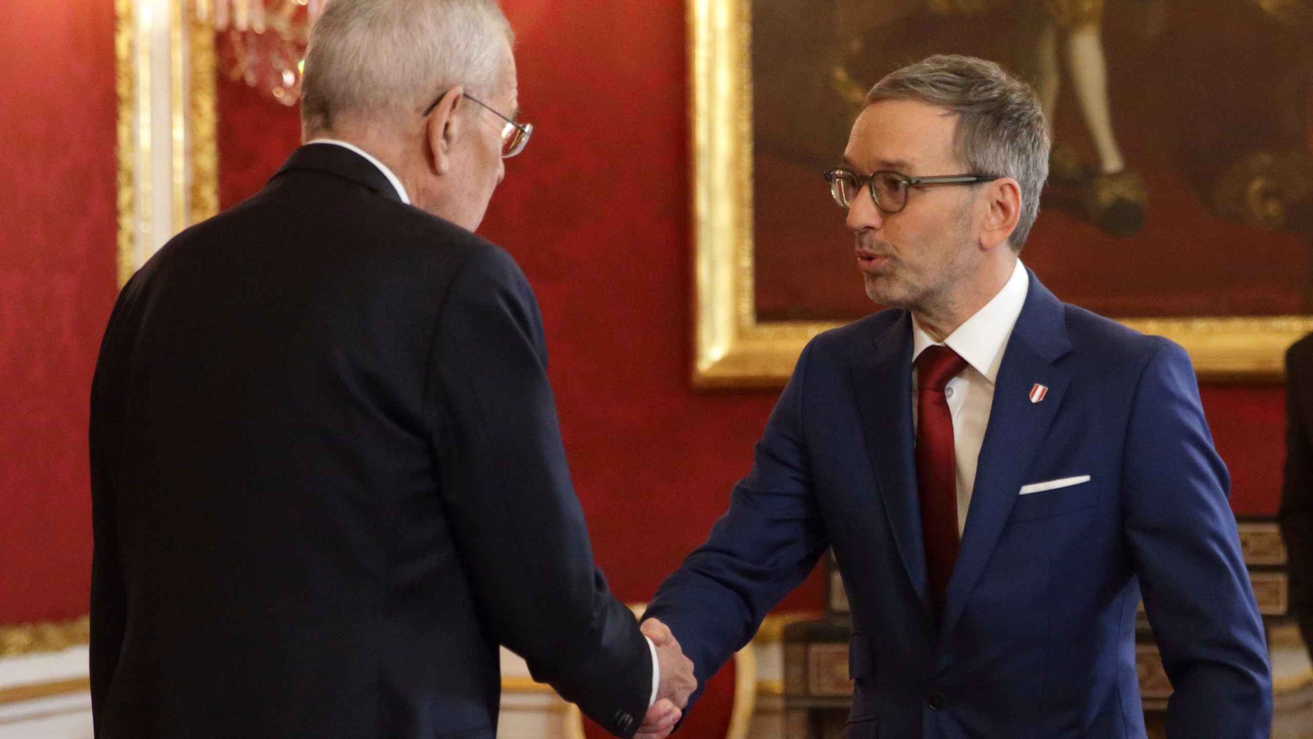 Austrian President Alexander Van der Bellen, left, welcomes head of the Freedom Party (FPOe) Herbert Kickl in his office, in Vienna, Austria, Monday, Jan. 6, 2025. (AP Photo/Heinz-Peter Bader)