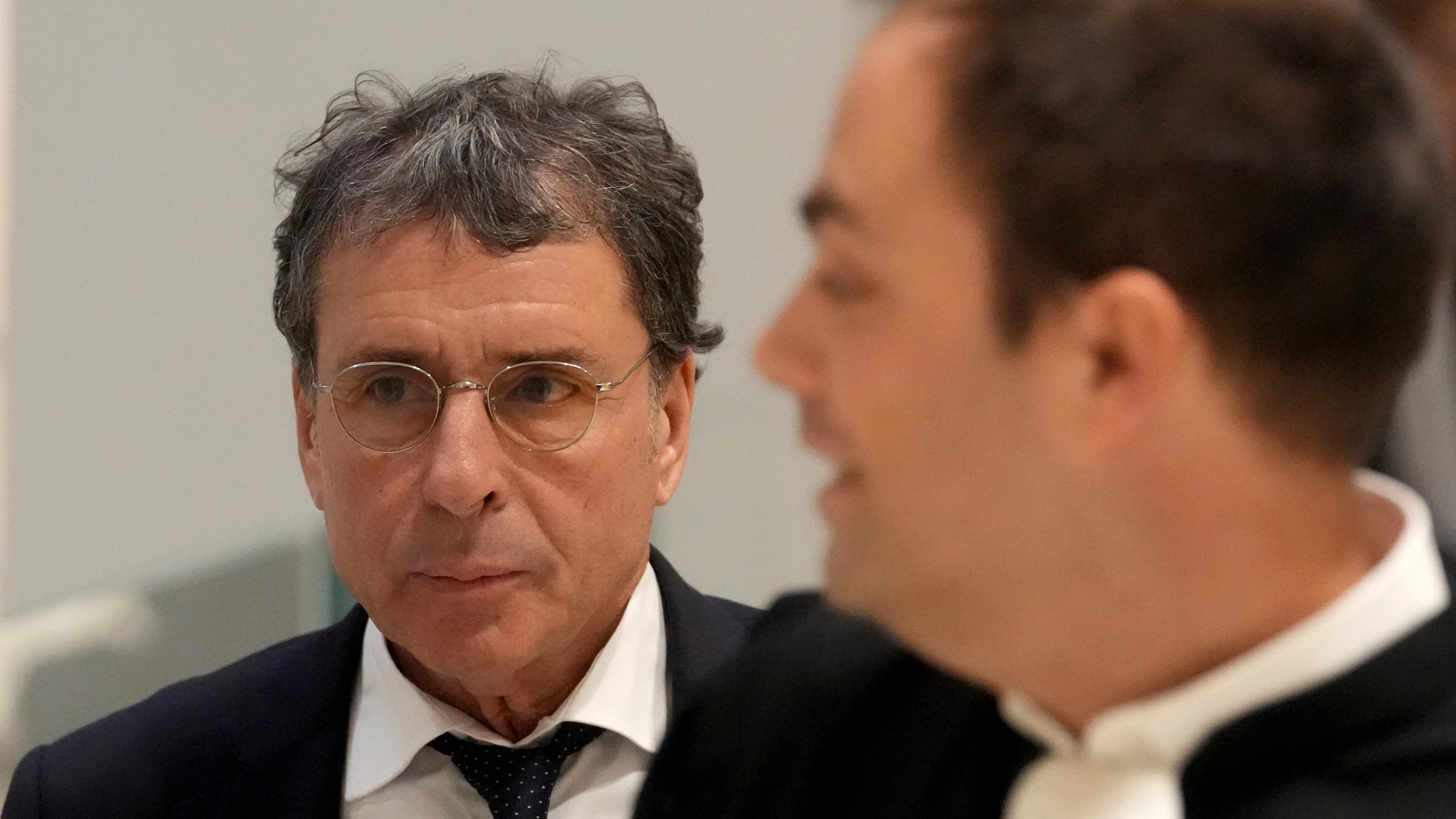 Alexandre Djouhri, left, a French-Algerian businessman, arrives to the courtroom as former French President Nicolas Sarkozy goes on trial over alleged illegal financing of his 2007 presidential campaign by the government of late Libyan leader Moammar Gadhafi, Monday, Jan. 6, 2025 in Paris. (AP Photo/Thibault Camus)