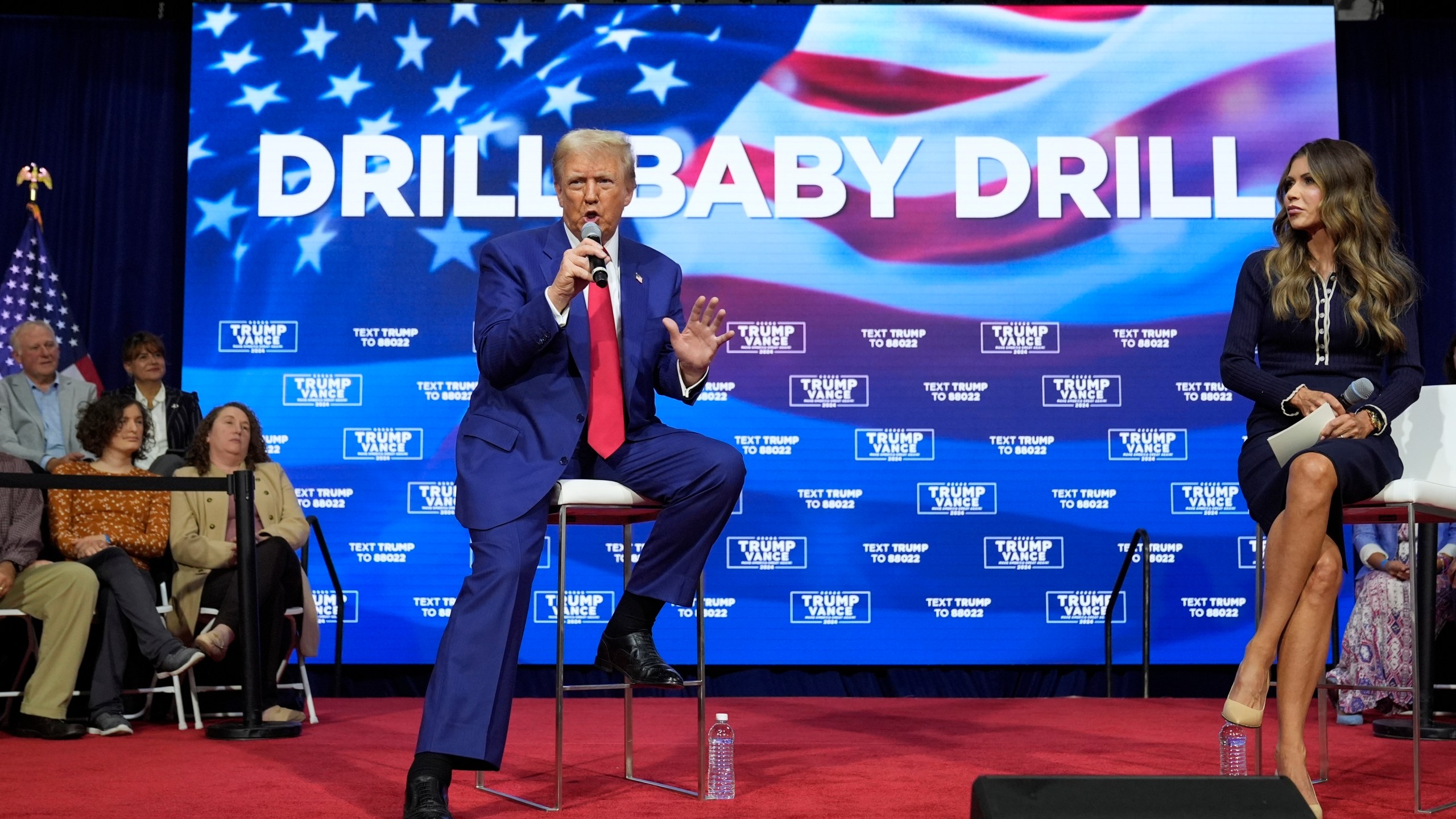 FILE - Republican presidential nominee former President Donald Trump speaks at a campaign town hall at the Greater Philadelphia Expo Center & Fairgrounds, Oct. 14, 2024, in Oaks, Pa., as moderator South Dakota Gov. Kristi Noem listens. (AP Photo/Alex Brandon, File)