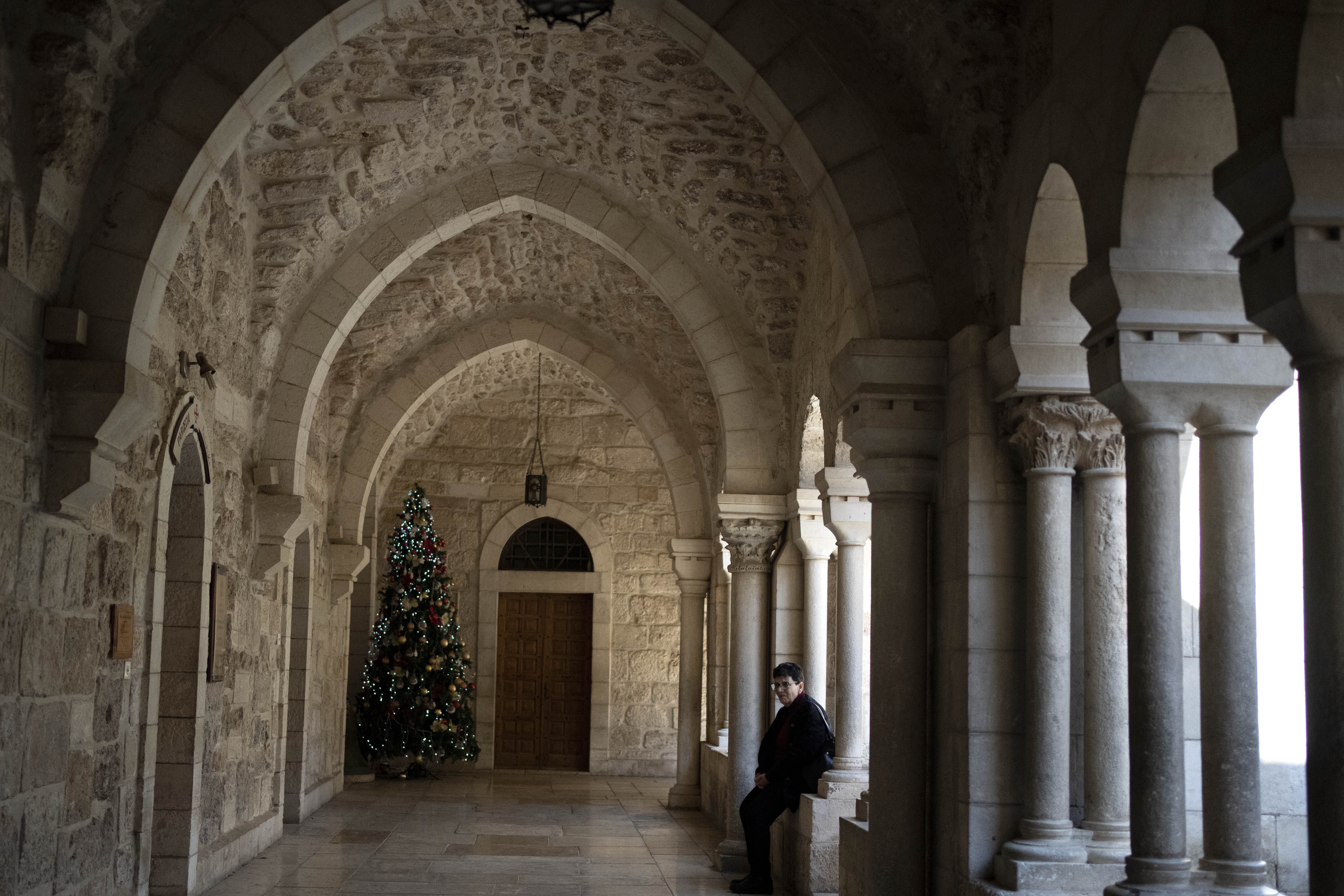 A lone Christmas tree is seen in the Church of the Nativity complex, where Christians believe Jesus Christ was born, ahead of Orthodox Christmas Eve mass in the West Bank city of Bethlehem, Monday, Jan. 6, 2025. (AP Photo/Maya Alleruzzo)